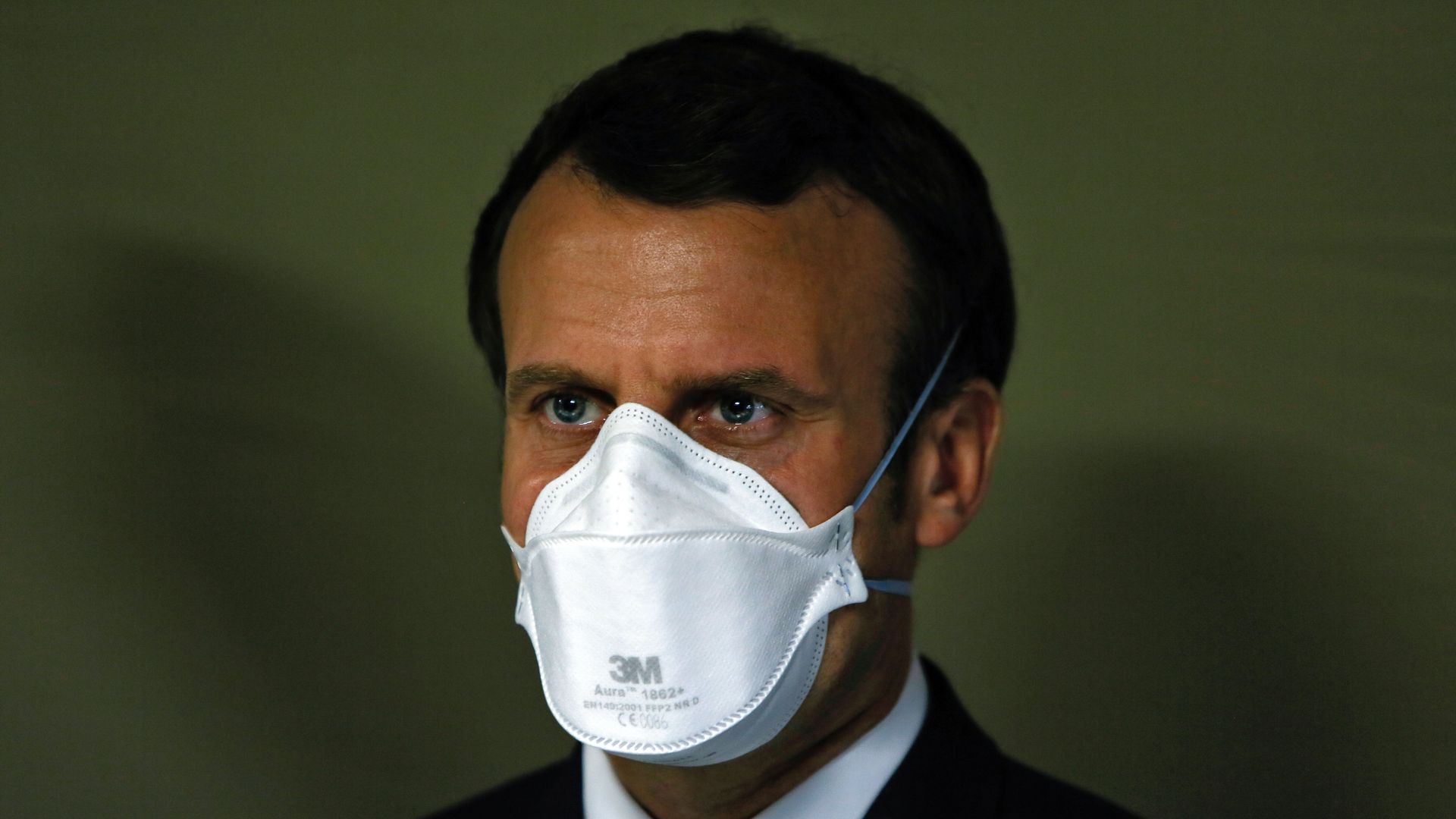 French President Emmanuel Macron wears a face mask during the visit of the military field hospital outside the Emile Muller Hospital in Mulhouse, eastern France,