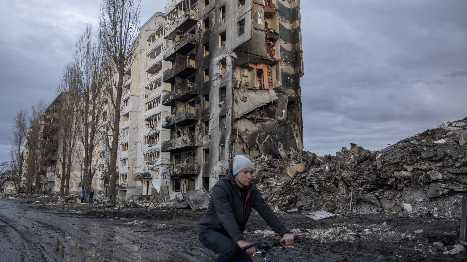 A person riding a bike past a destroyed building in the town of Borodyanka in the Kyiv region on April 9. 