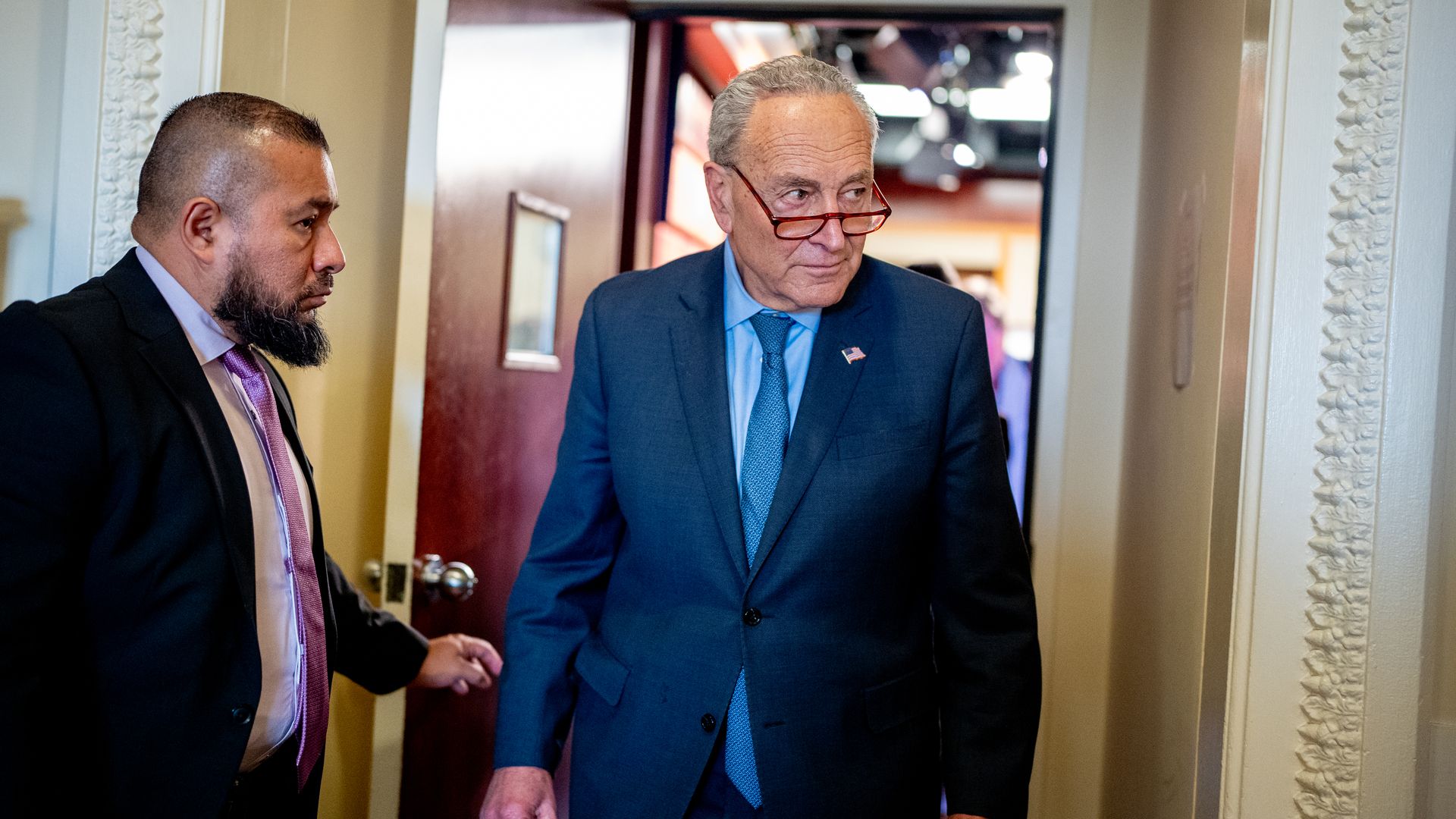 Senate Majority Leader Chuck Schumer (D-NY) leaves a news conference after impeachment proceedings 