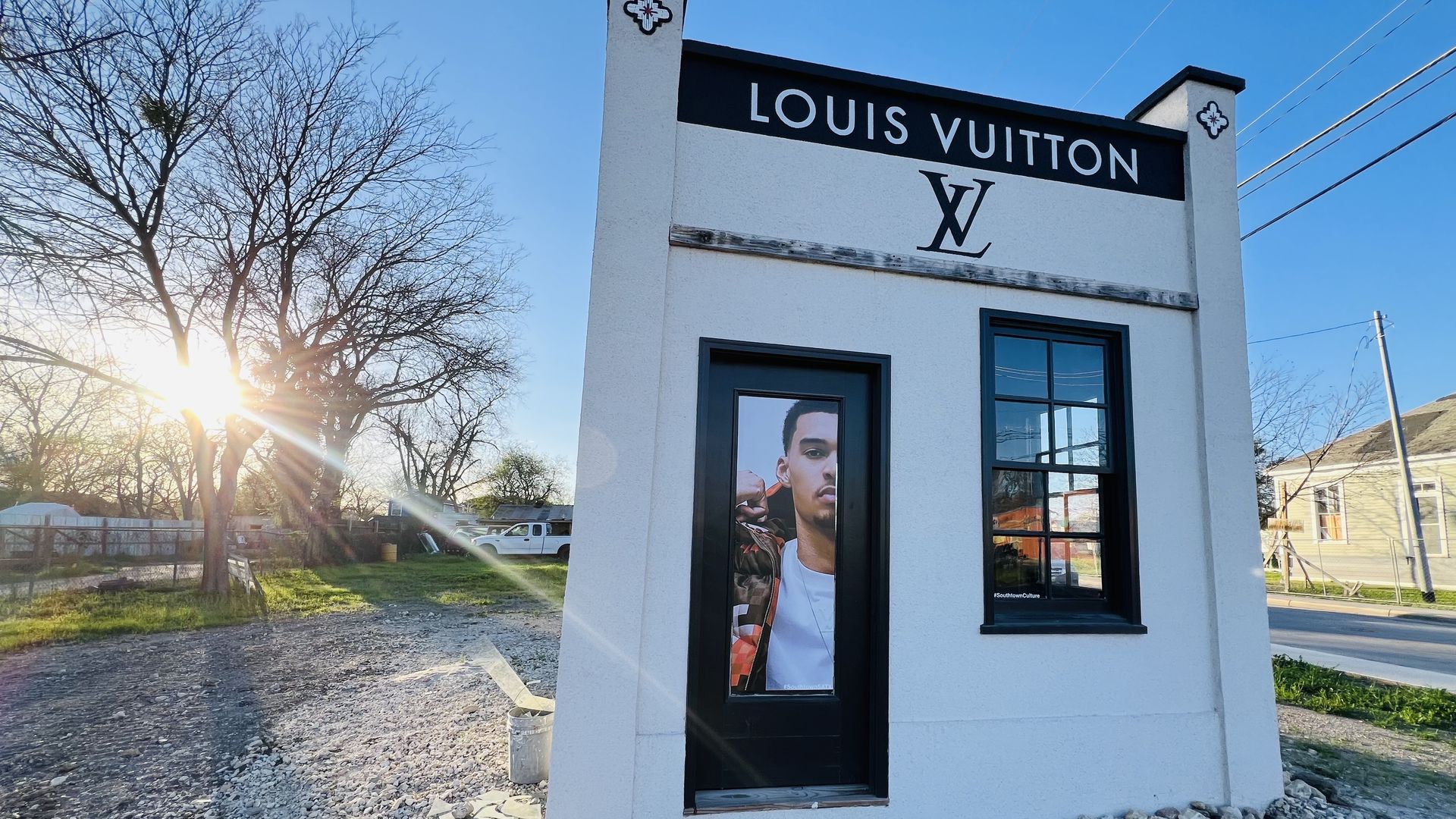 A small beige structure with featuring Wembanyama's photo and the Louis Vuitton logos. 