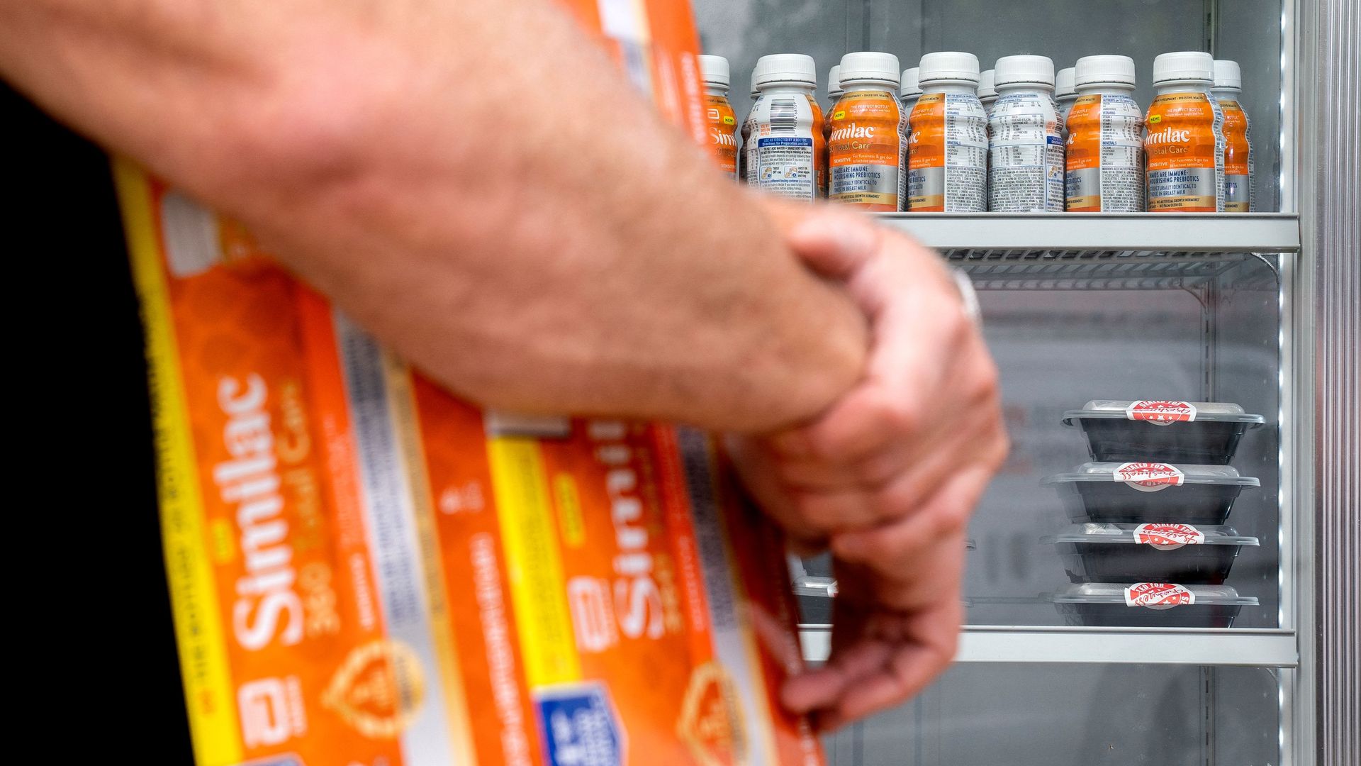 Person carries Similac baby formula box