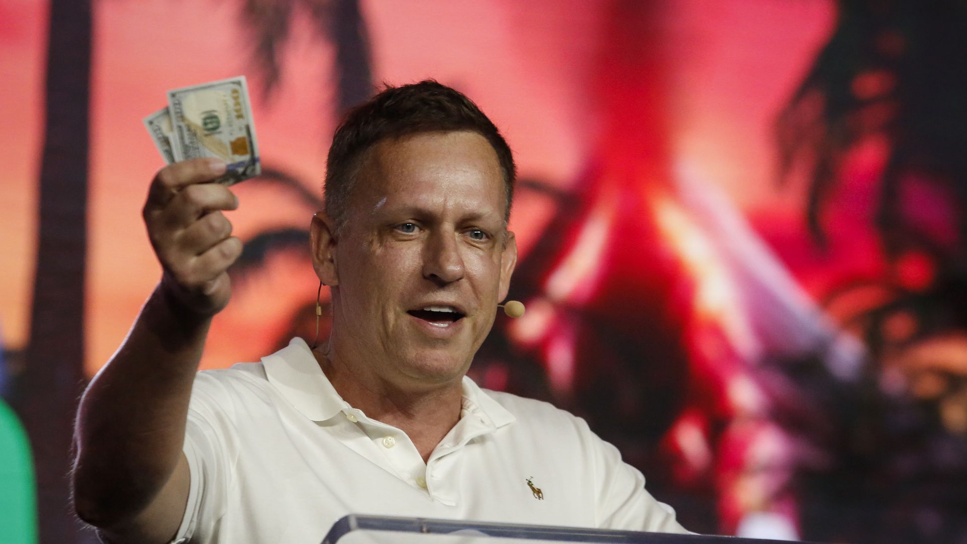 Peter Thiel holding $100 bill