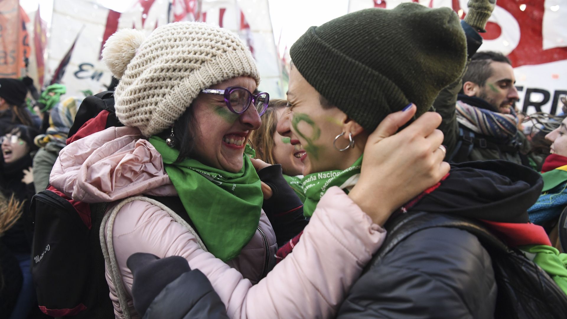 Two women hold each other, celebrating after Argentina lawmakers approve a bill for abortion rights.