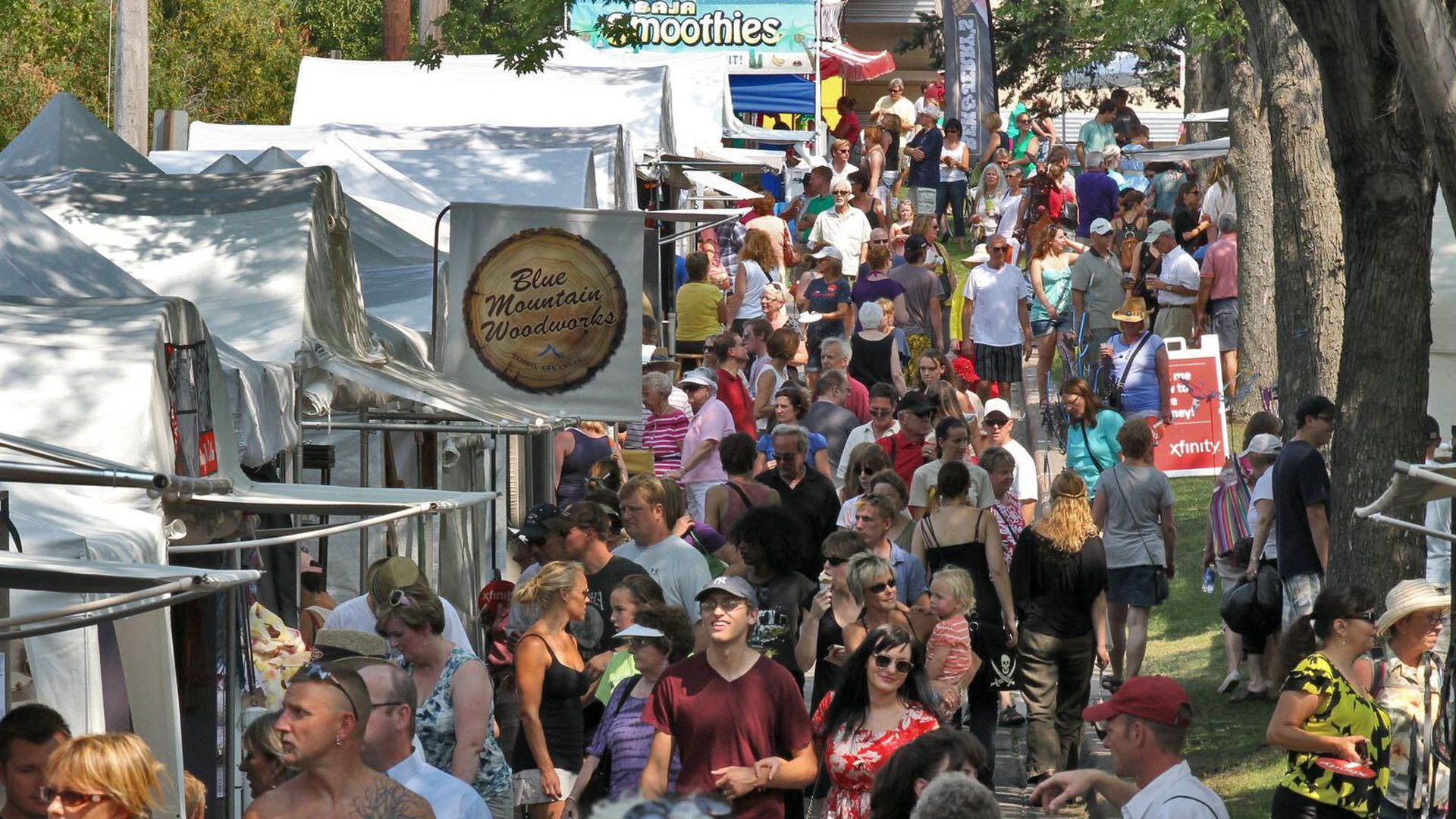 Large crowds gather by tents at Minneapolis' Uptown Art Fair