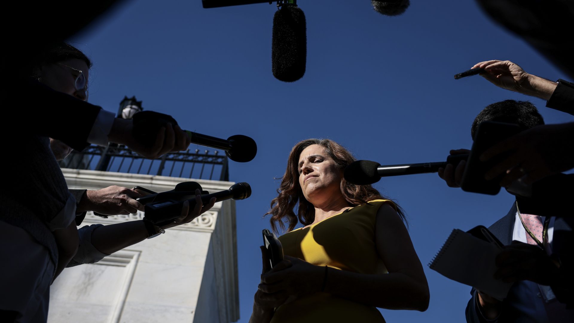 Rep. Nancy Mace is seen surrounded by reporters after she voted to hold Steve Bannon in contempt of Congress.