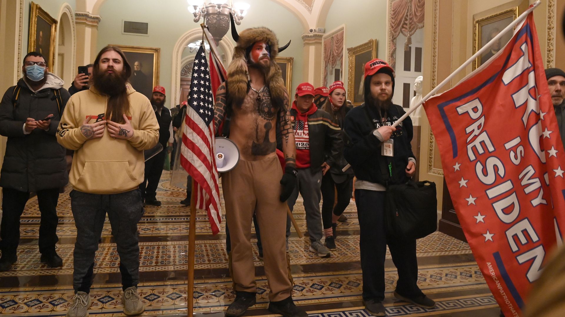 Pro-Trump forces stand outside the U.S. Senate chamber today after breaching the Capitol.