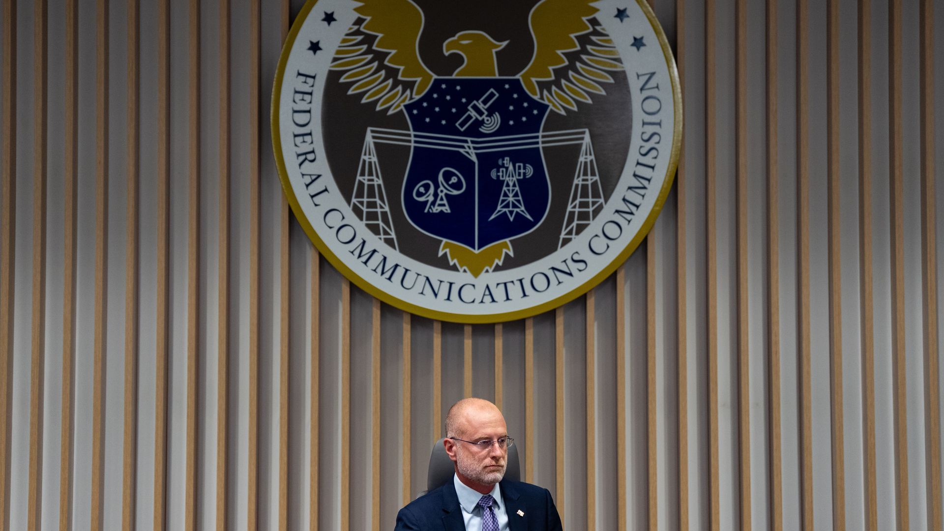 Man in front of FCC logo