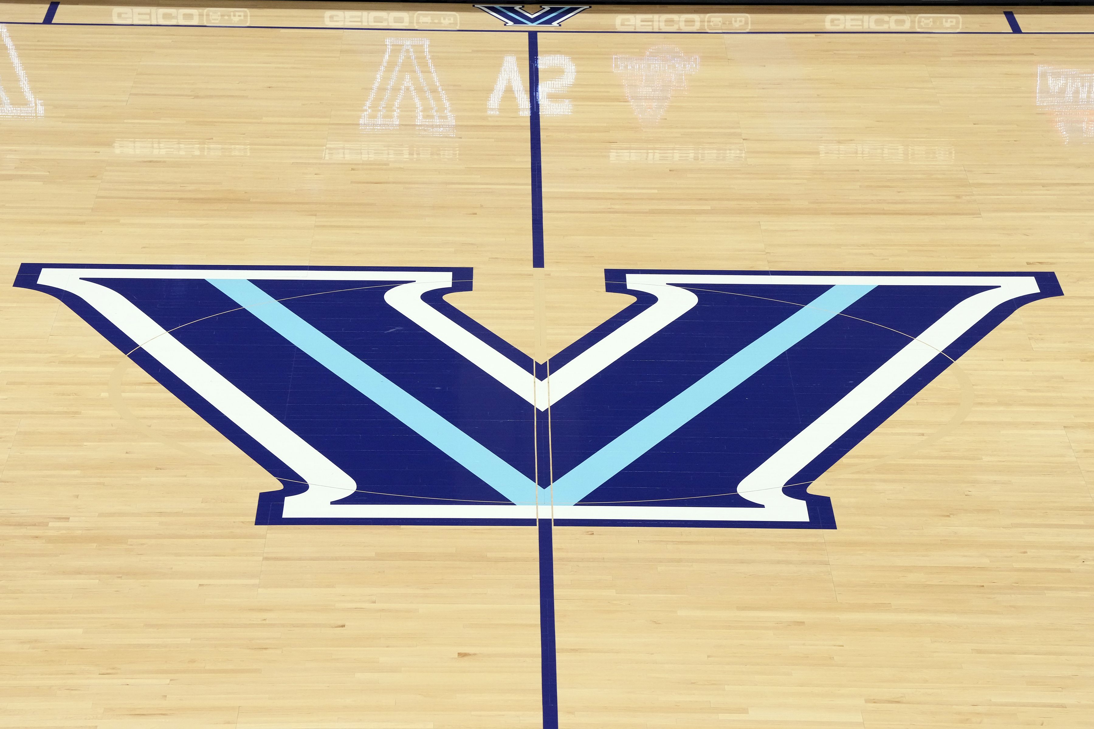 Photo of a "V" written on a basketball court. 