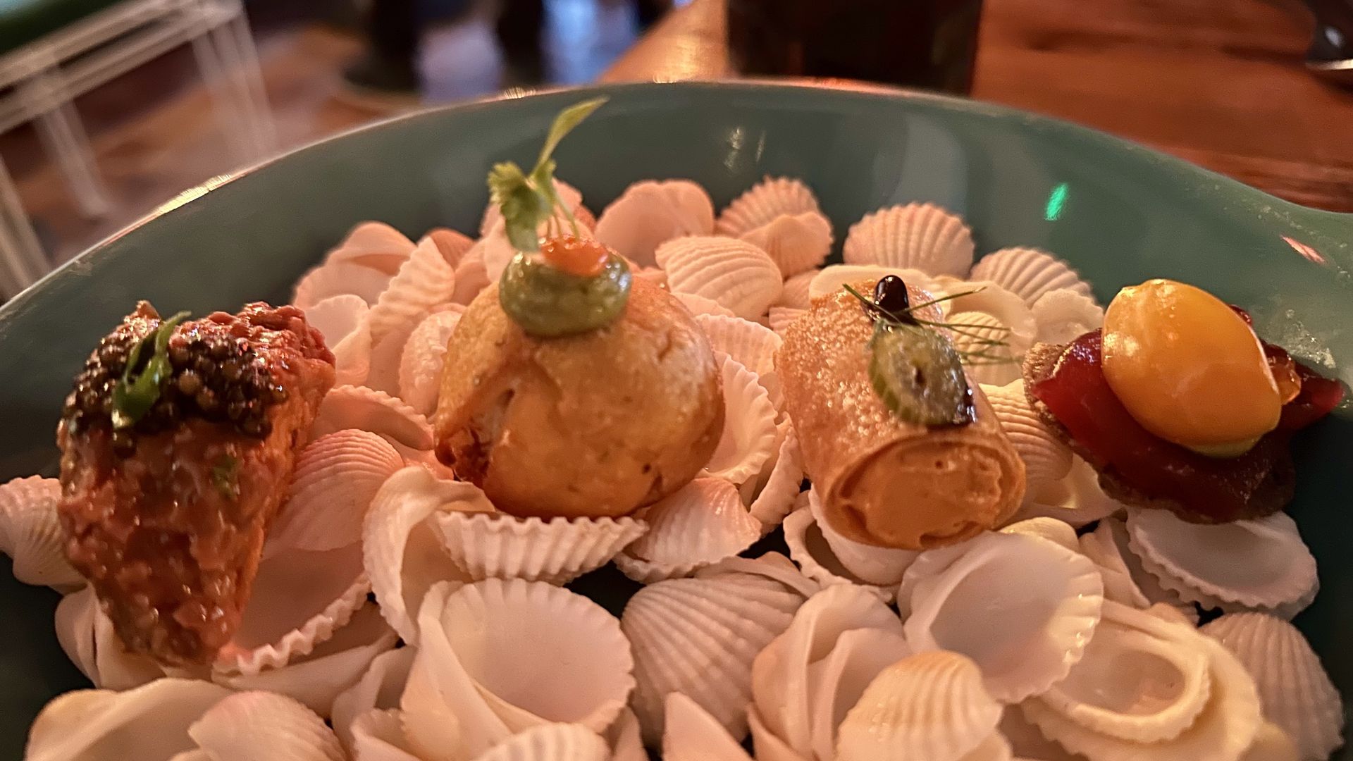 A photo of single-bite appetizers on seashells