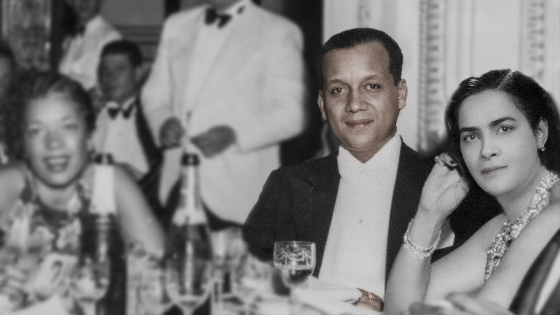 Photo of a man sitting at a dinner table. 