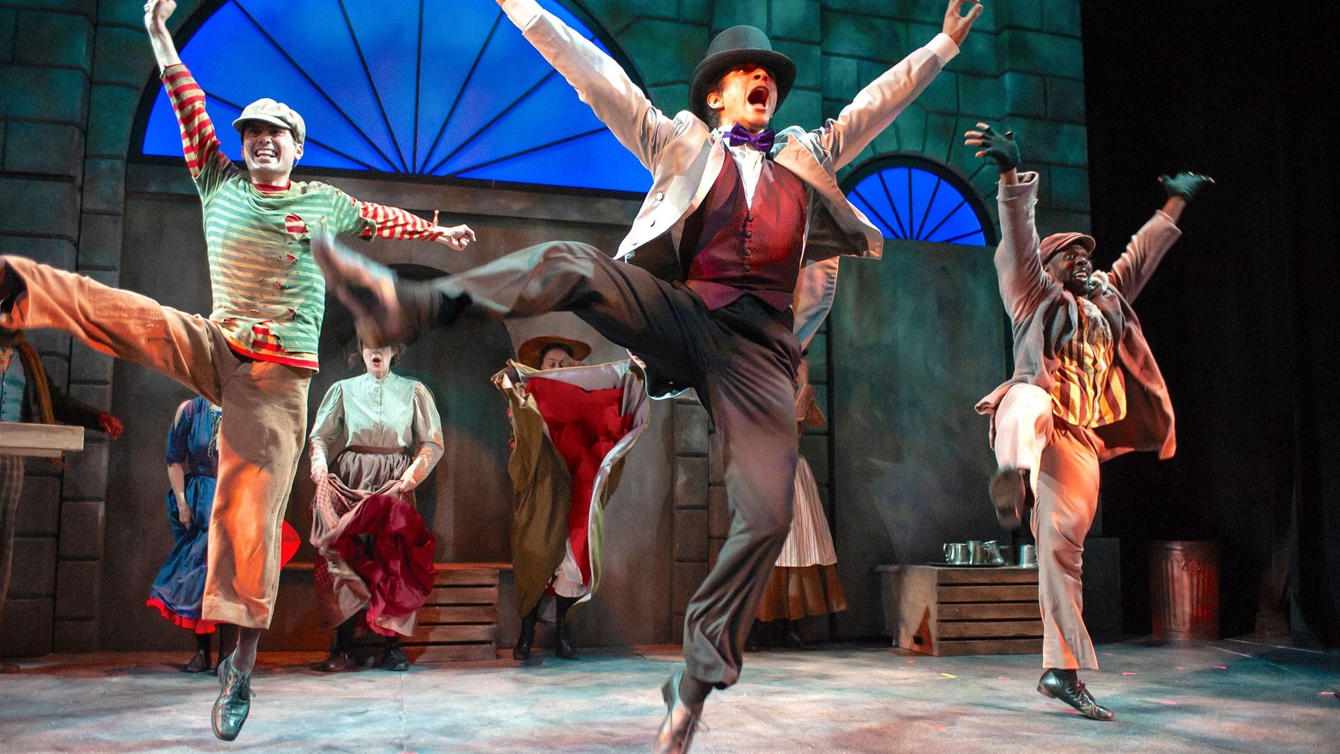 Photo of three performers dancing on stage