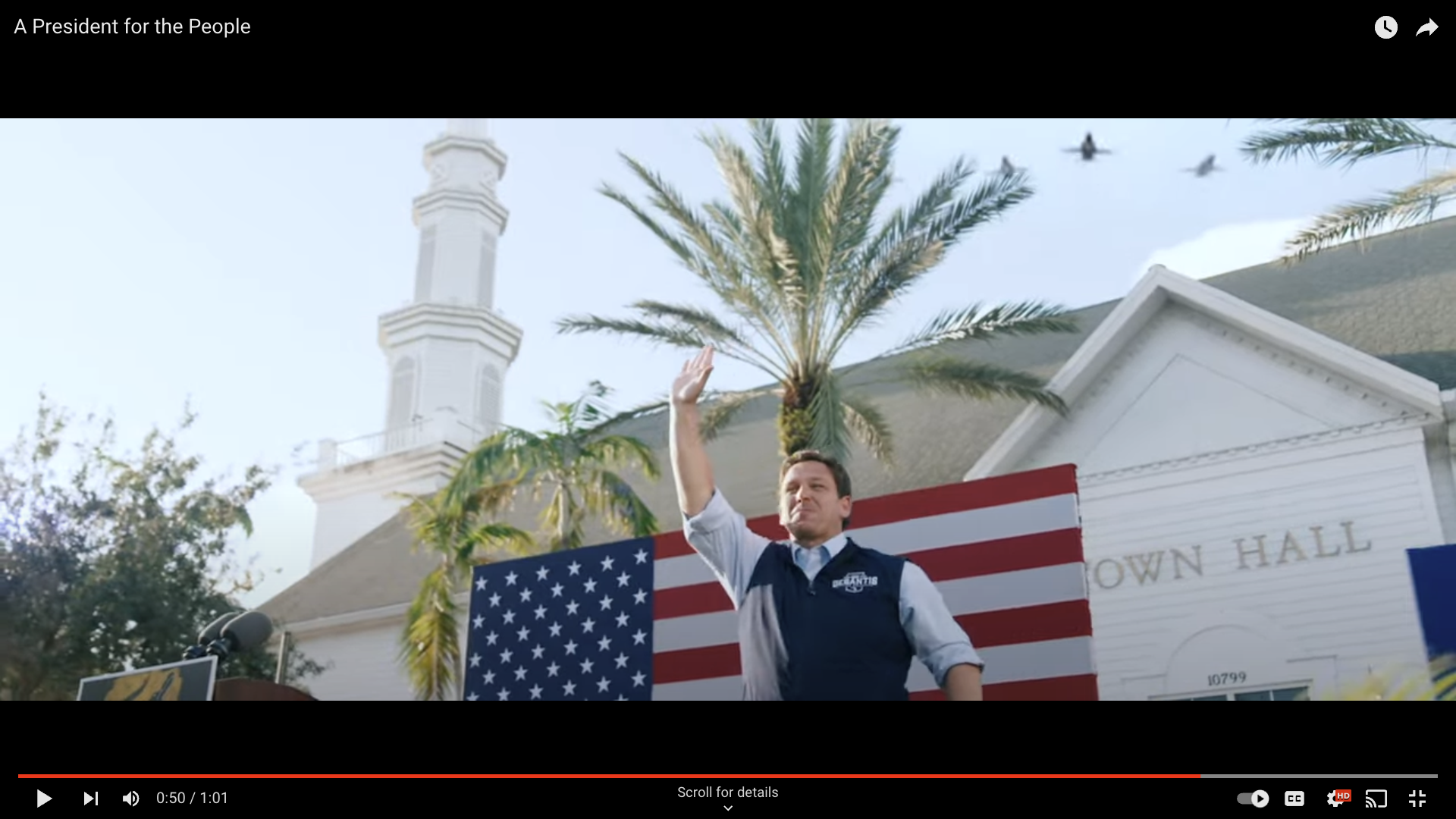 Video image of Florida Governor Ron DeSantis waving as fighter jets fly above.
