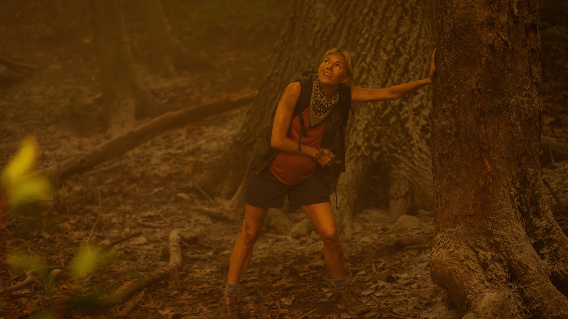 Actress Sienna Miller seen in a smoky forest in an episode of the Apple TV+ series "Extrapolations."