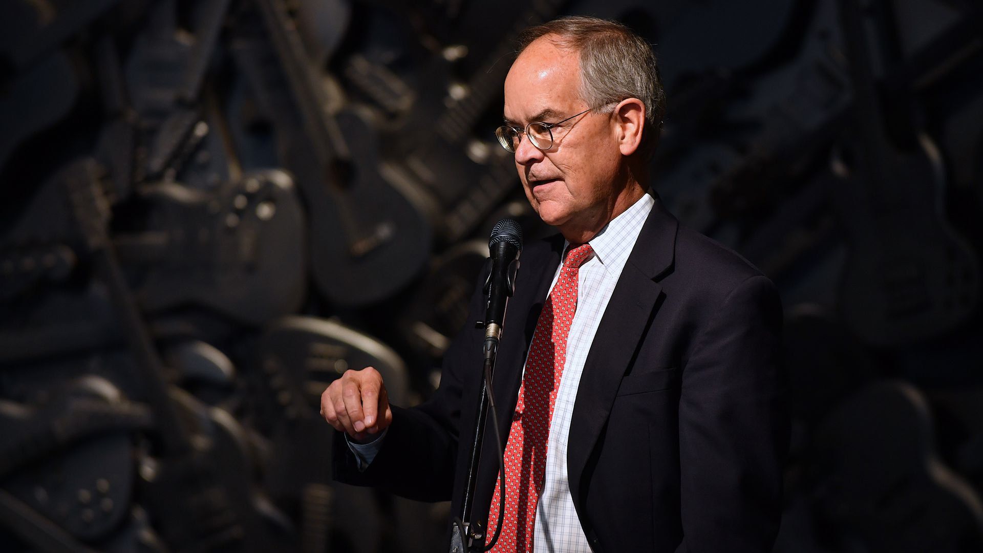 U.S. Rep. Jim Cooper speaks on stage in front of a microphone.
