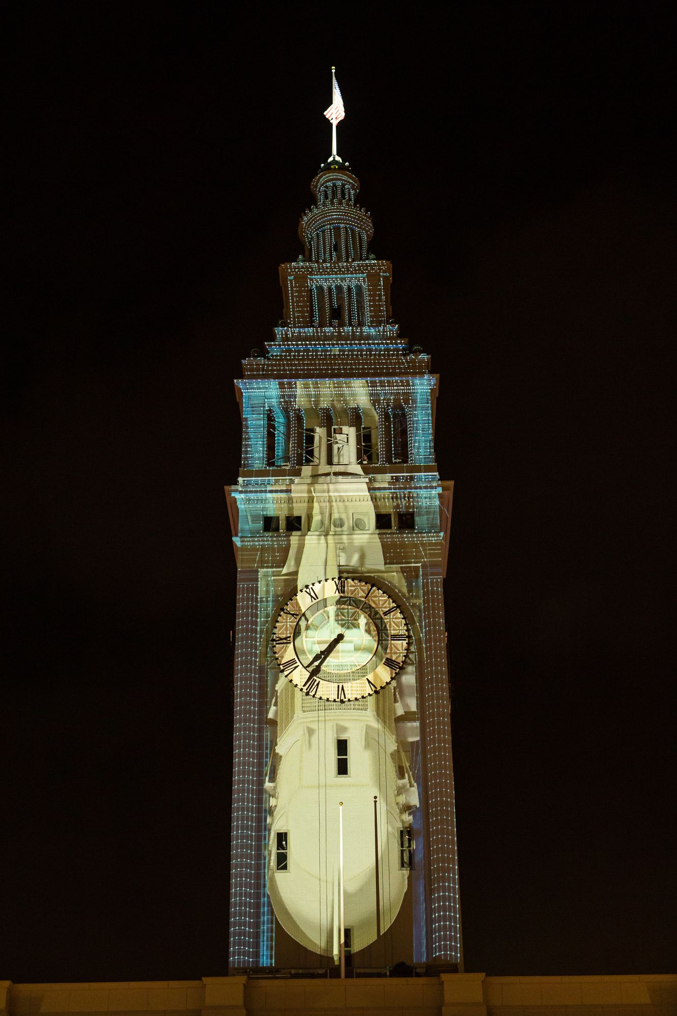 Photo of an art piece projected onto a clock tower