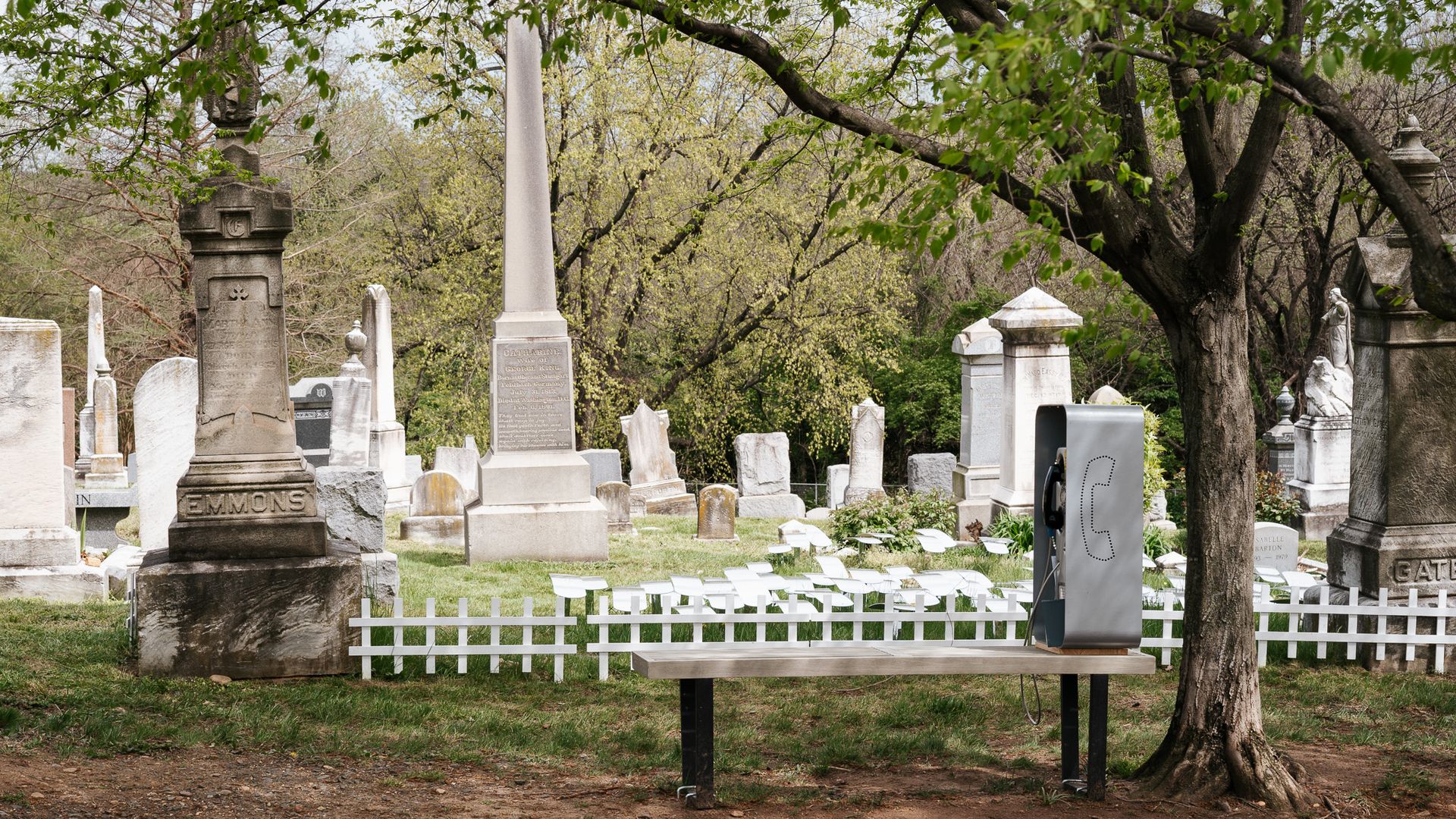 A phone booth sits on a bench outside of Congressional Cemetery.