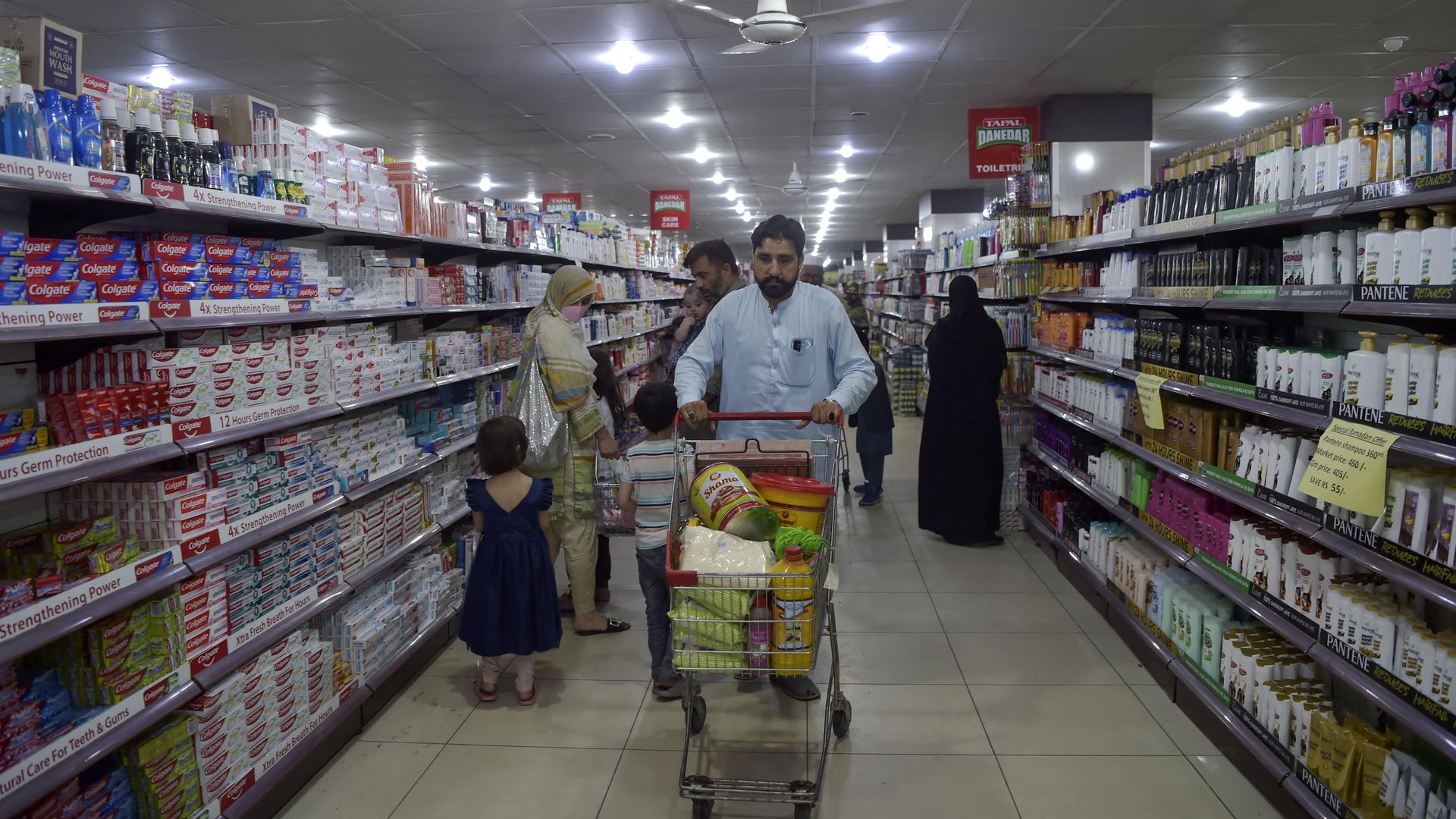 People shop at a supermarket at the start of Islam's holy month of Ramadan, in Peshawar on April 2, 2022.