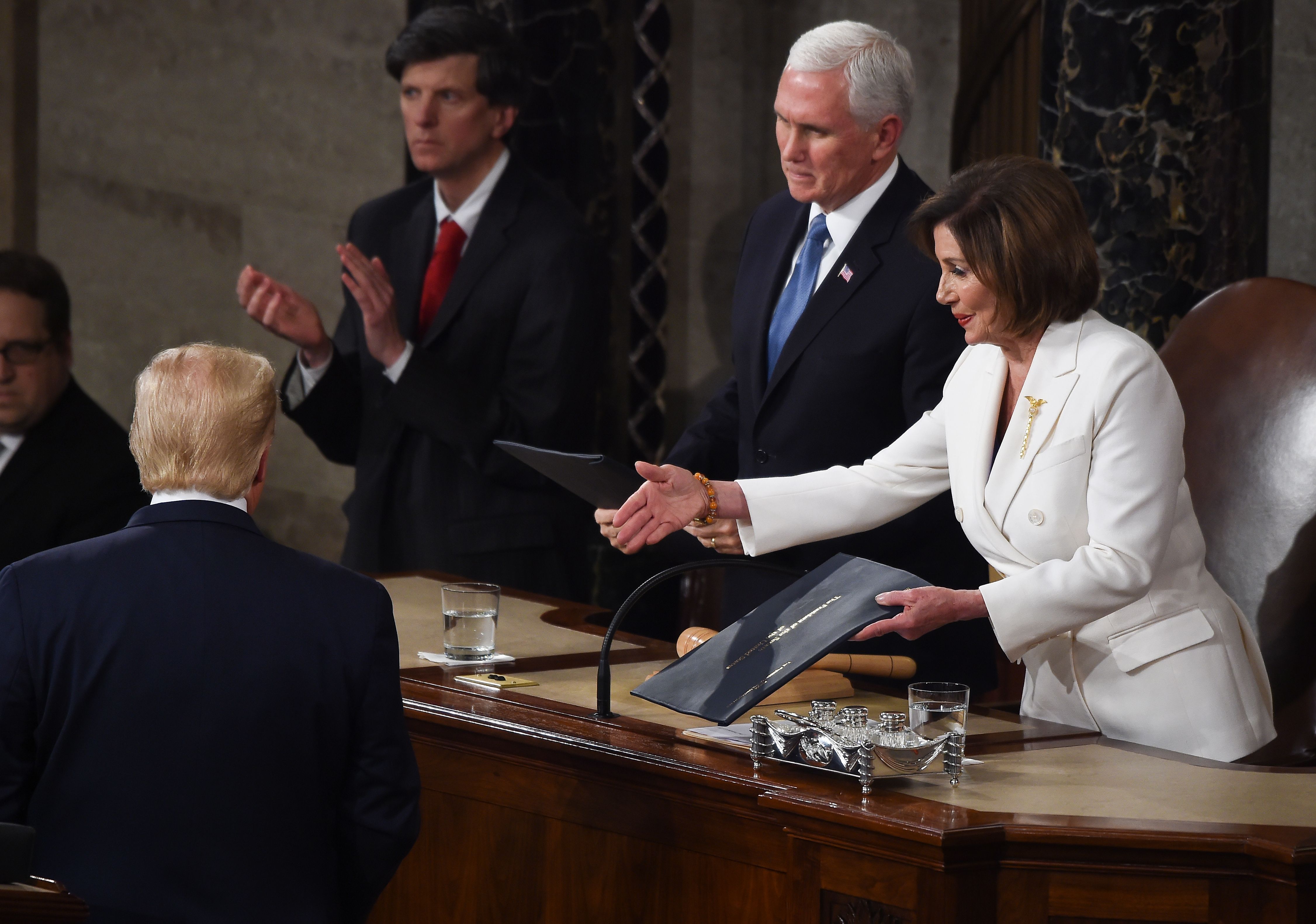 Speaker of the US House of Representatives Nancy Pelosi extends a hand to US president Donald Trump ahead of the State of the Union address 