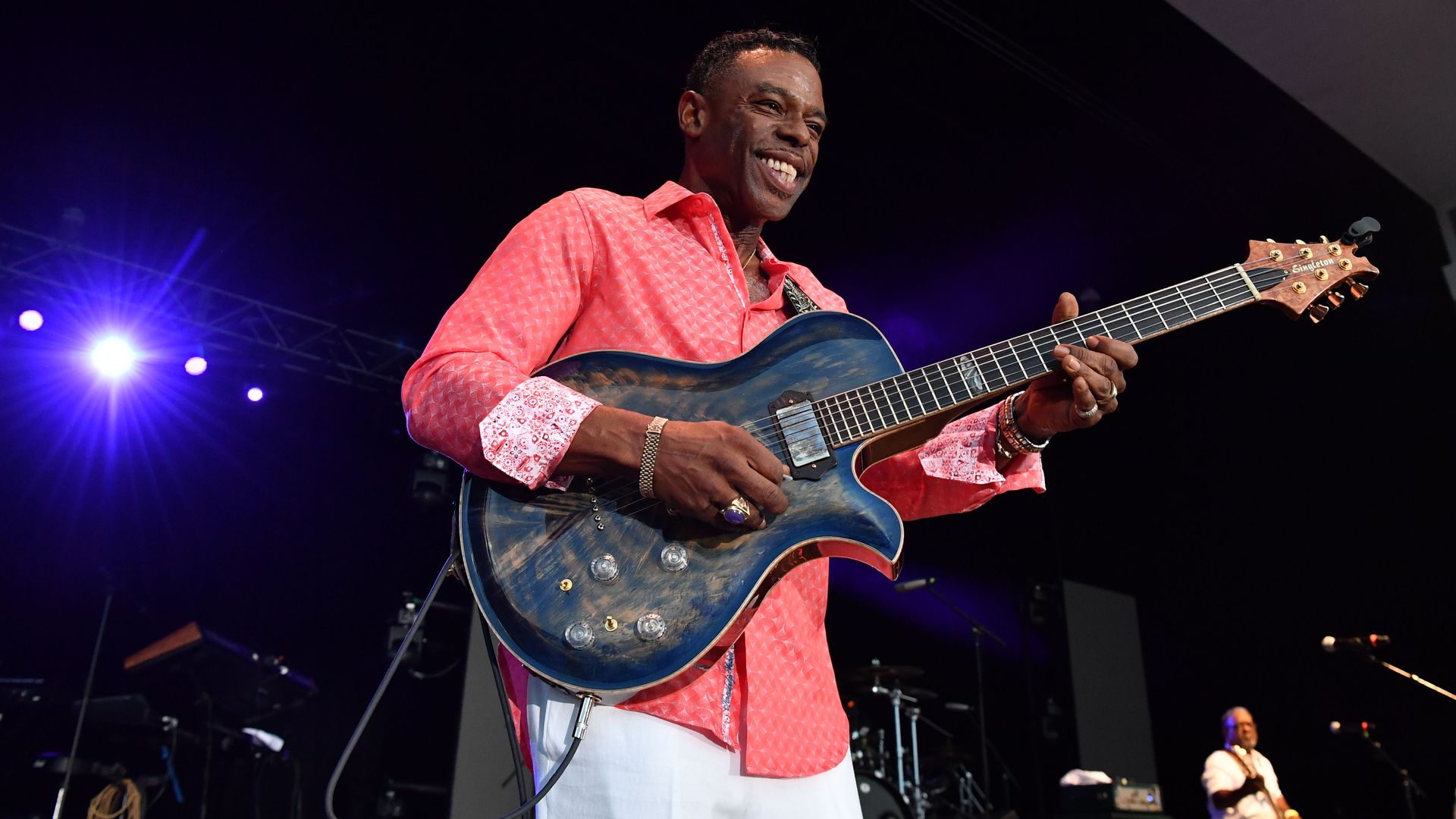 man playing guitar on stage