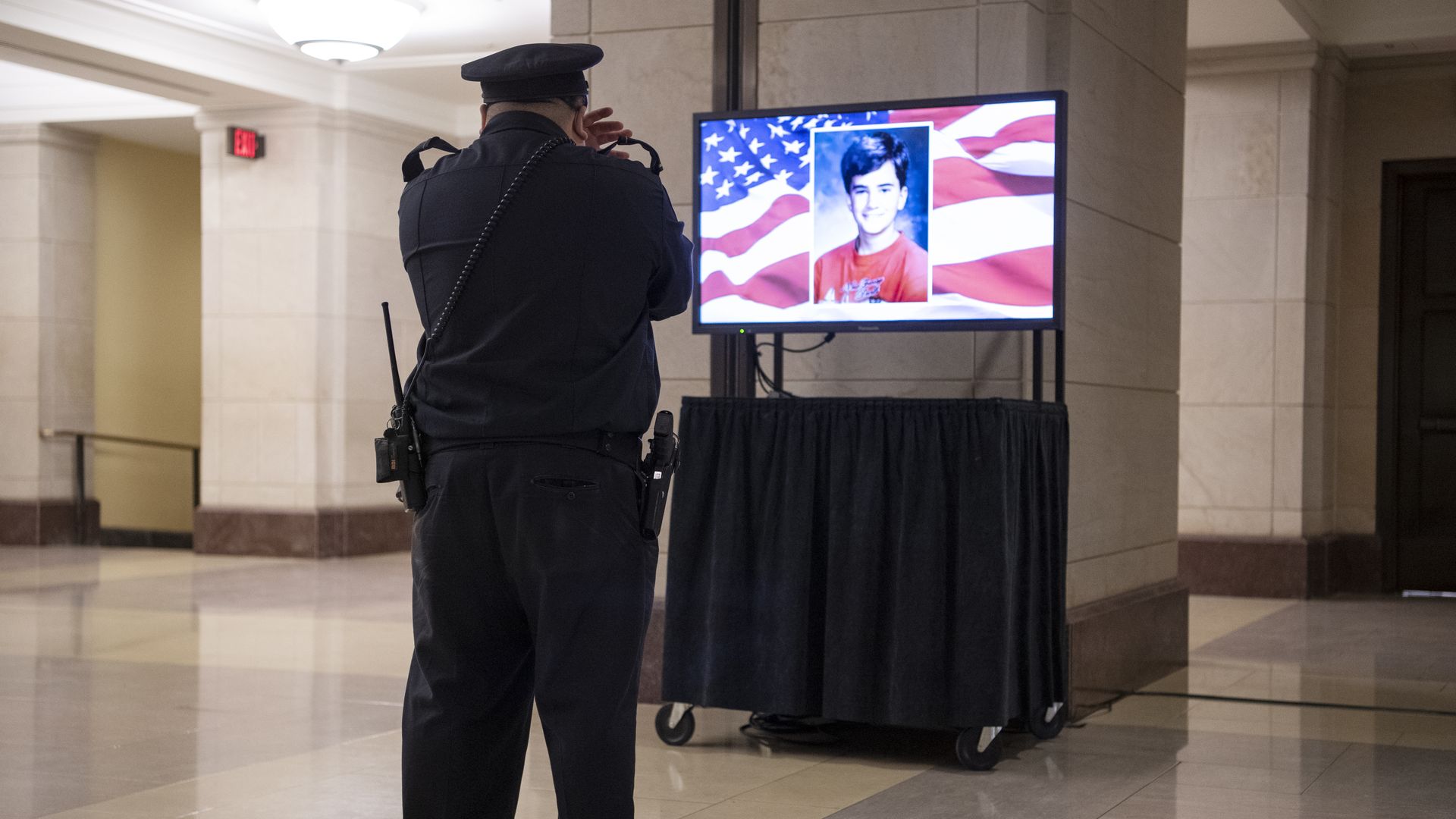 A Capitol Police officer watches the ceremony for the late Officer Brian Sicknick, as his remains lie in honor in the Rotunda on Wednesday, February 3, 2021.