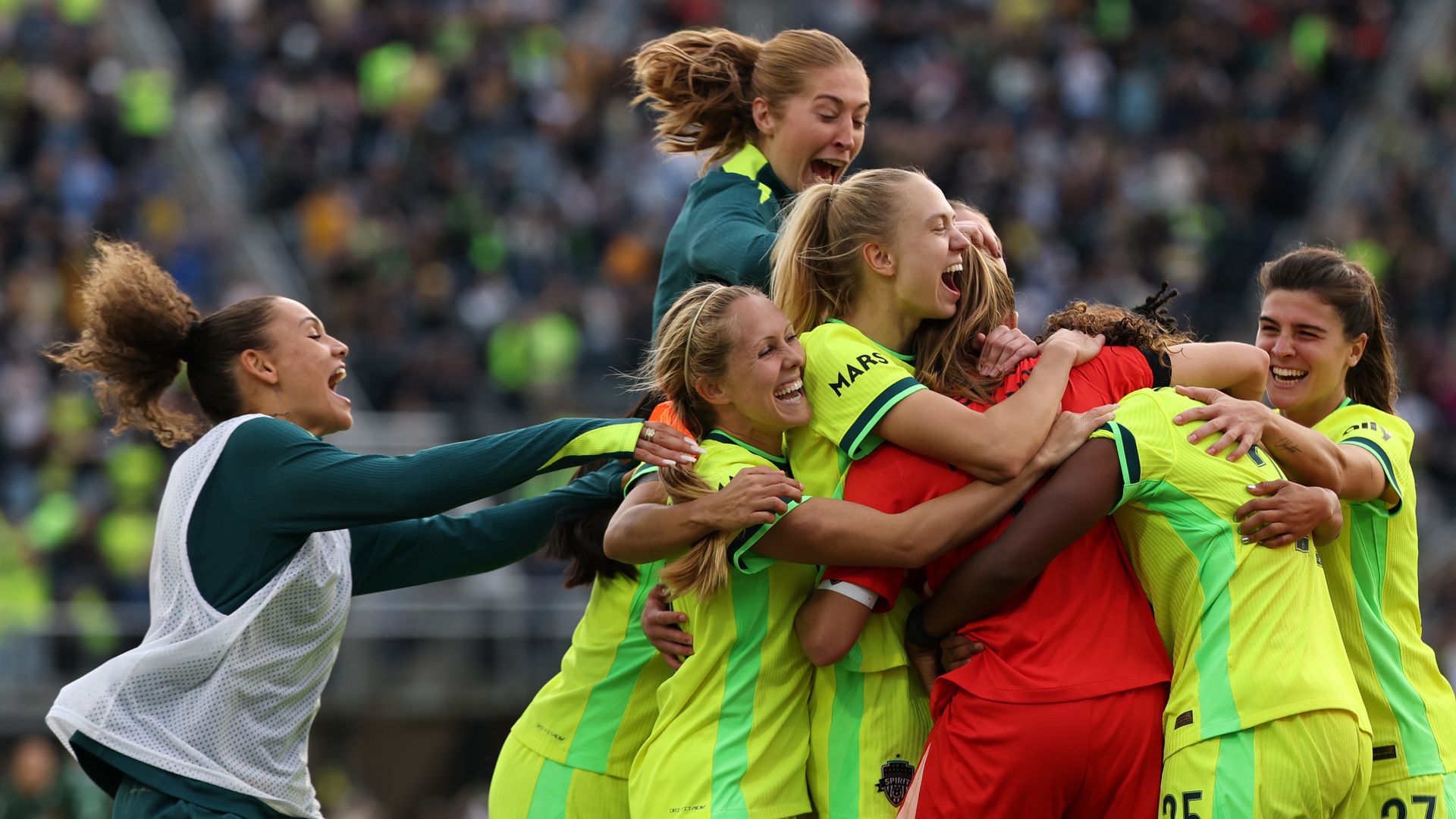 Spirit players celebrate after a win on the field