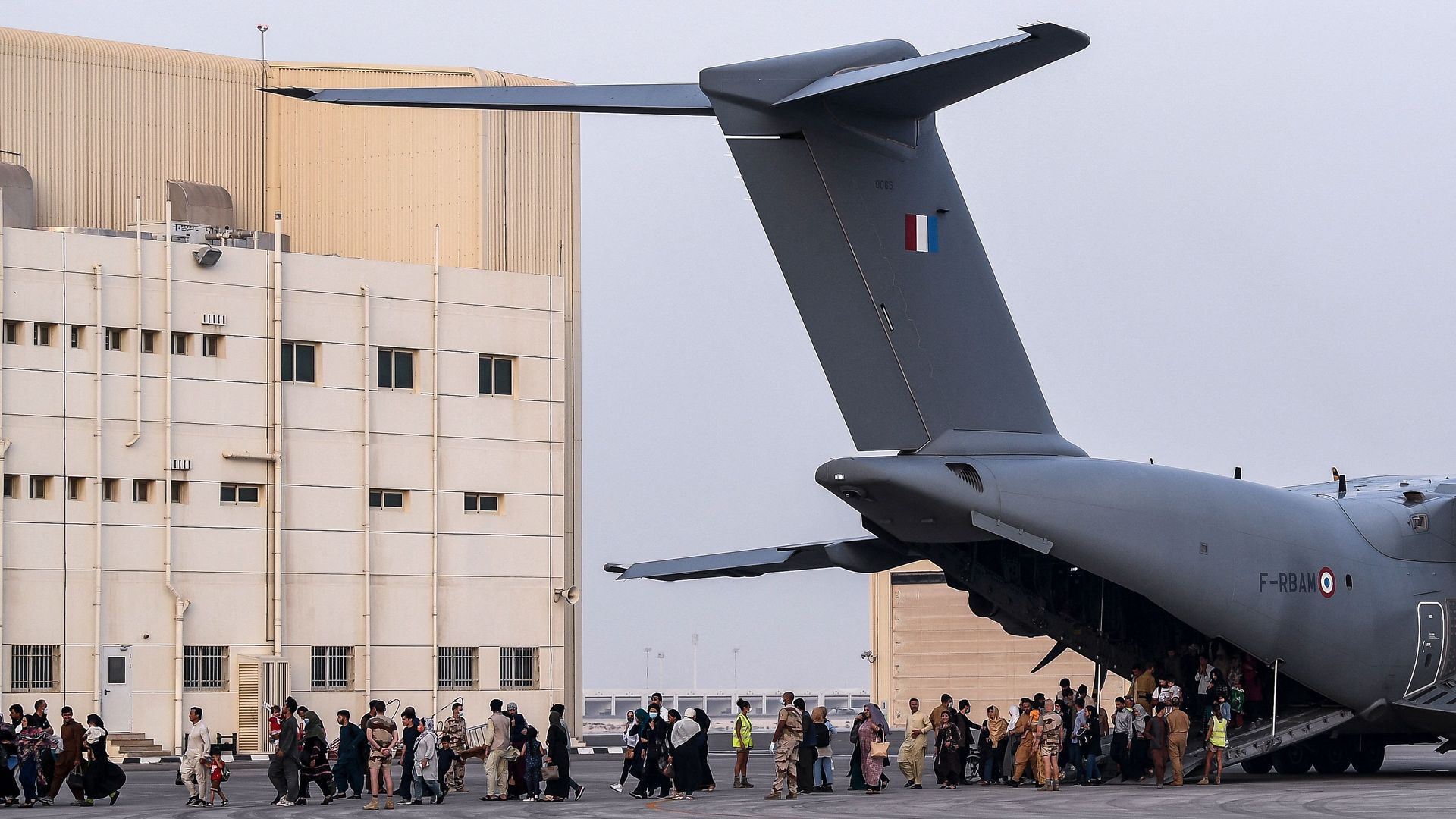 People disembark from a Airbus A400M military transport aircraft at the French military air base 104 of Al Dhafra, near Abu Dhabi, on August 23, after being evacuated from Kabul