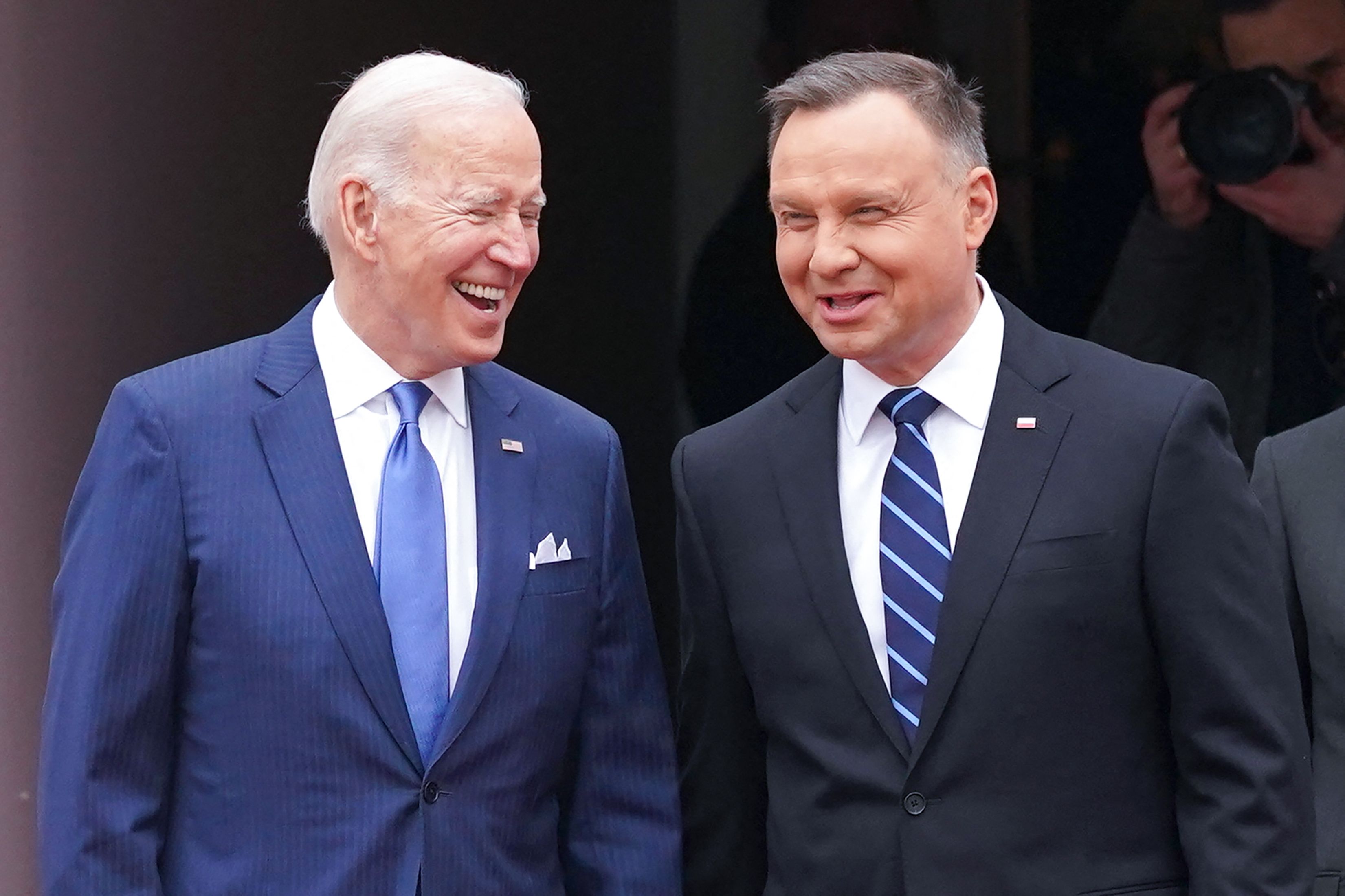 President Joe Biden (L) and Polish President Andrzej Duda shake react during an official wecoming ceremony prior to a meeting in Warsaw on March 26, 2022.