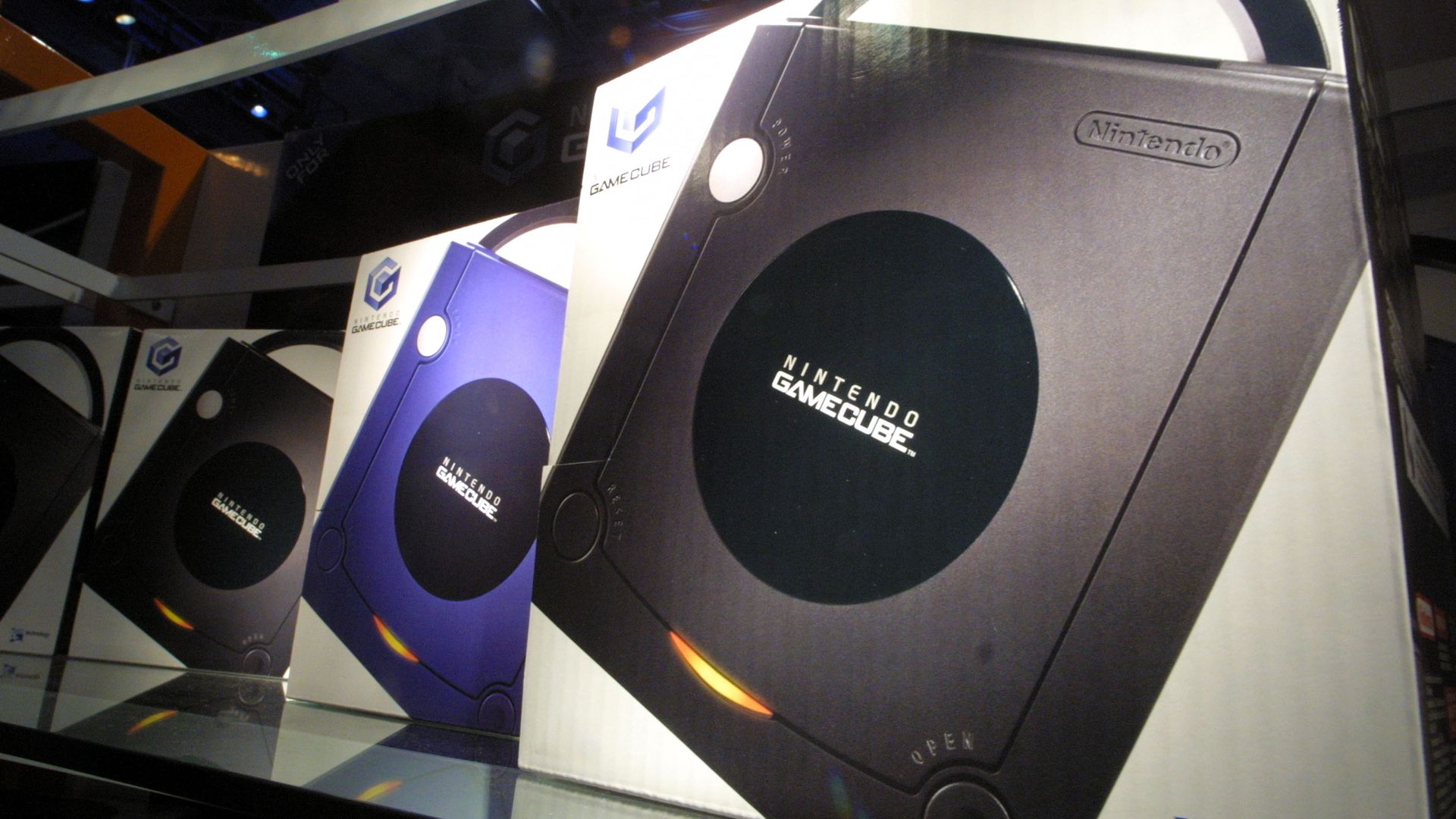 Photo of boxes of GameCube consoles, each sporting a signature handle