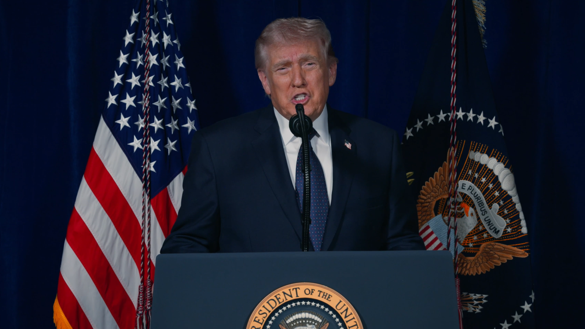 President Trump speaking at a podium.