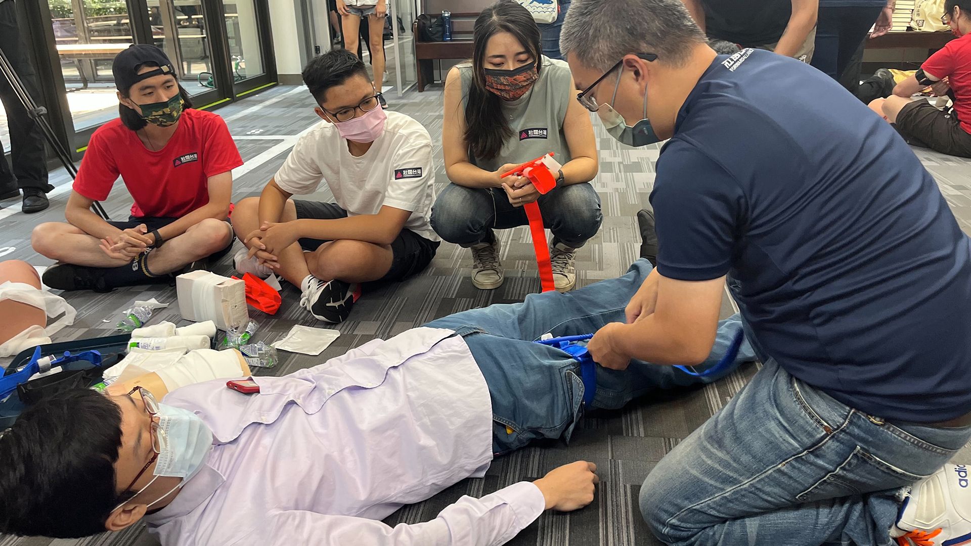 A trainer demonstrates how to apply a tourniquet during a civil defense training in Taipei, Taiwan on July 23, 2022.