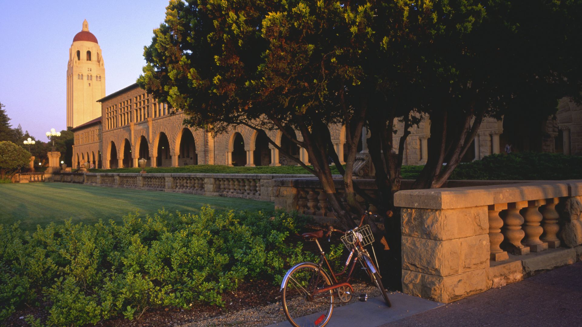 Photo of a bicycle parked outside an iconic Stanford University campus building