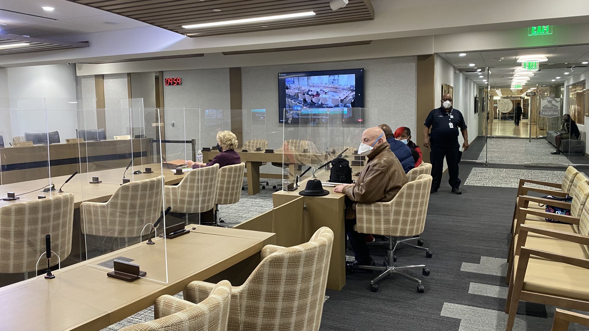 Public commenters sit in chairs waiting to speak at City Council's committee meeting Monday.