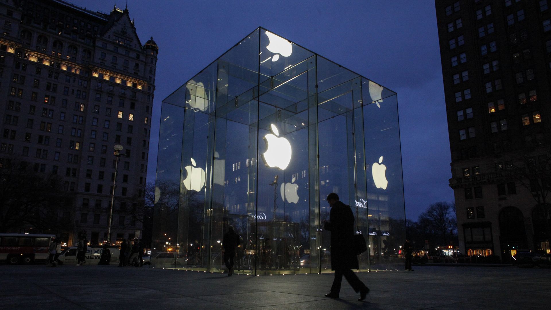 Apple store lit up at night.