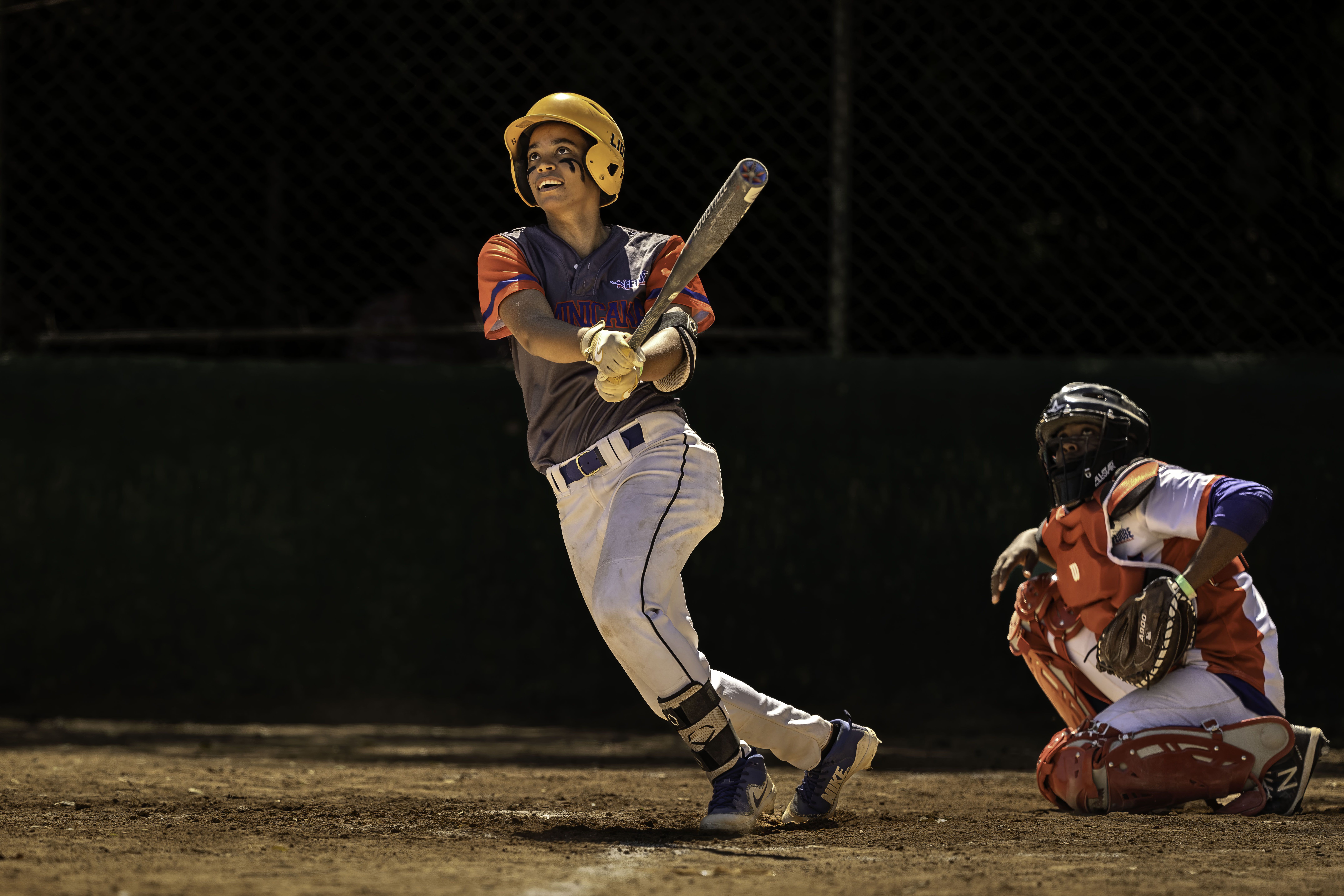Woman hits a baseball