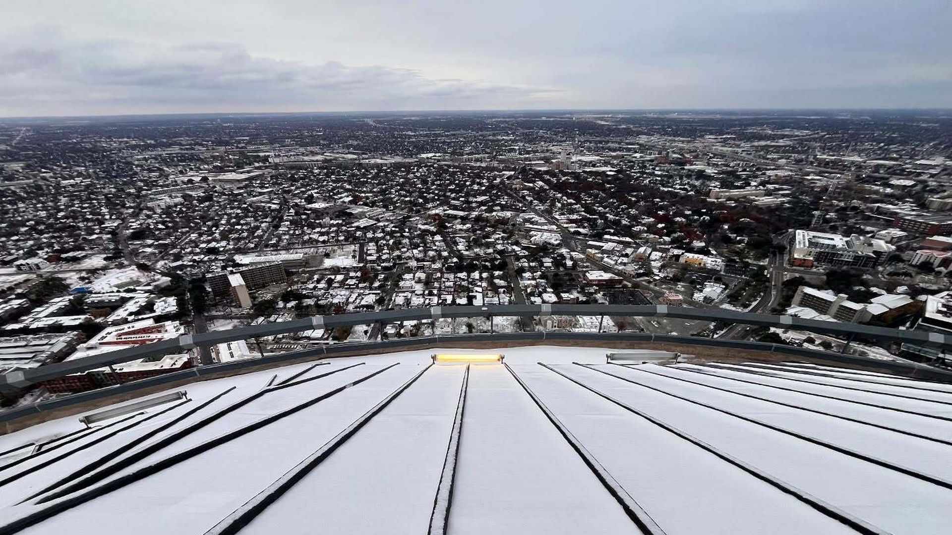 A view of San Antonio covered in light snow from the top of the Tower of the Americas.
