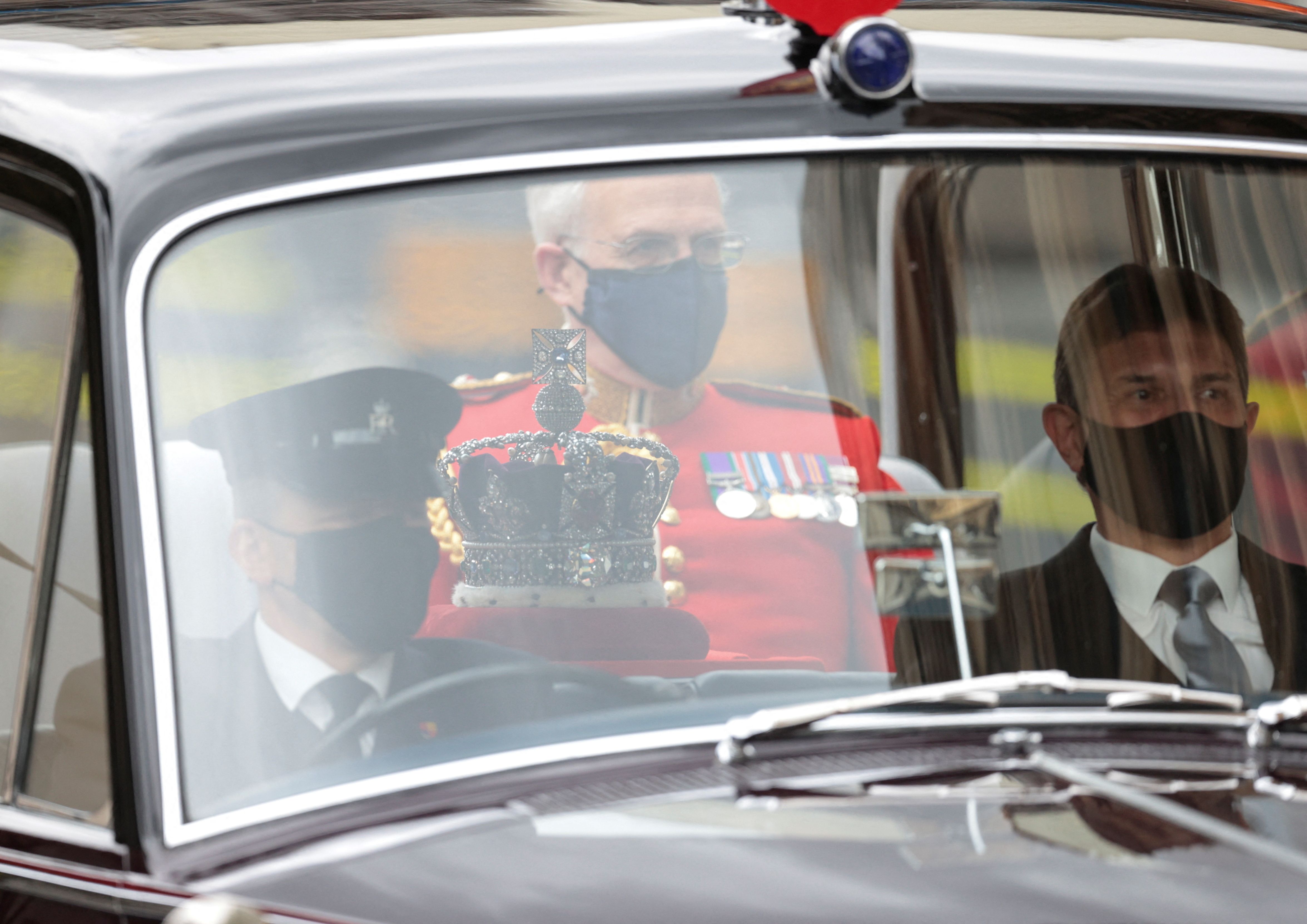 A crown being transported in a car.