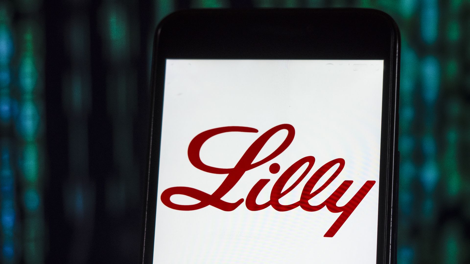 A phone with the Eli Lilly logo on the screen.