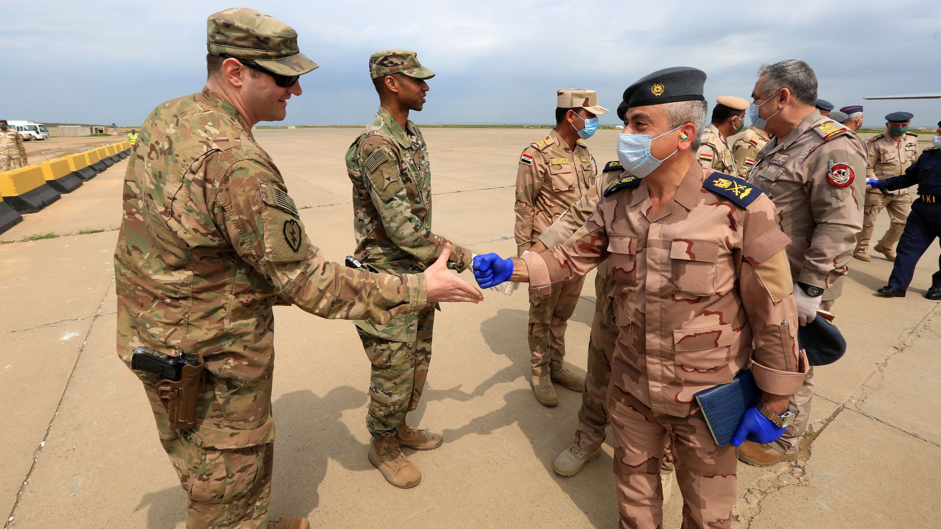 Soldiers are seen with face masks as the U.S.-led coalition against the Daesh/ISIS terror group on Thursday formally handed over to Iraq the Qayyarah airbase in southern Mosul, Iraq on March 26