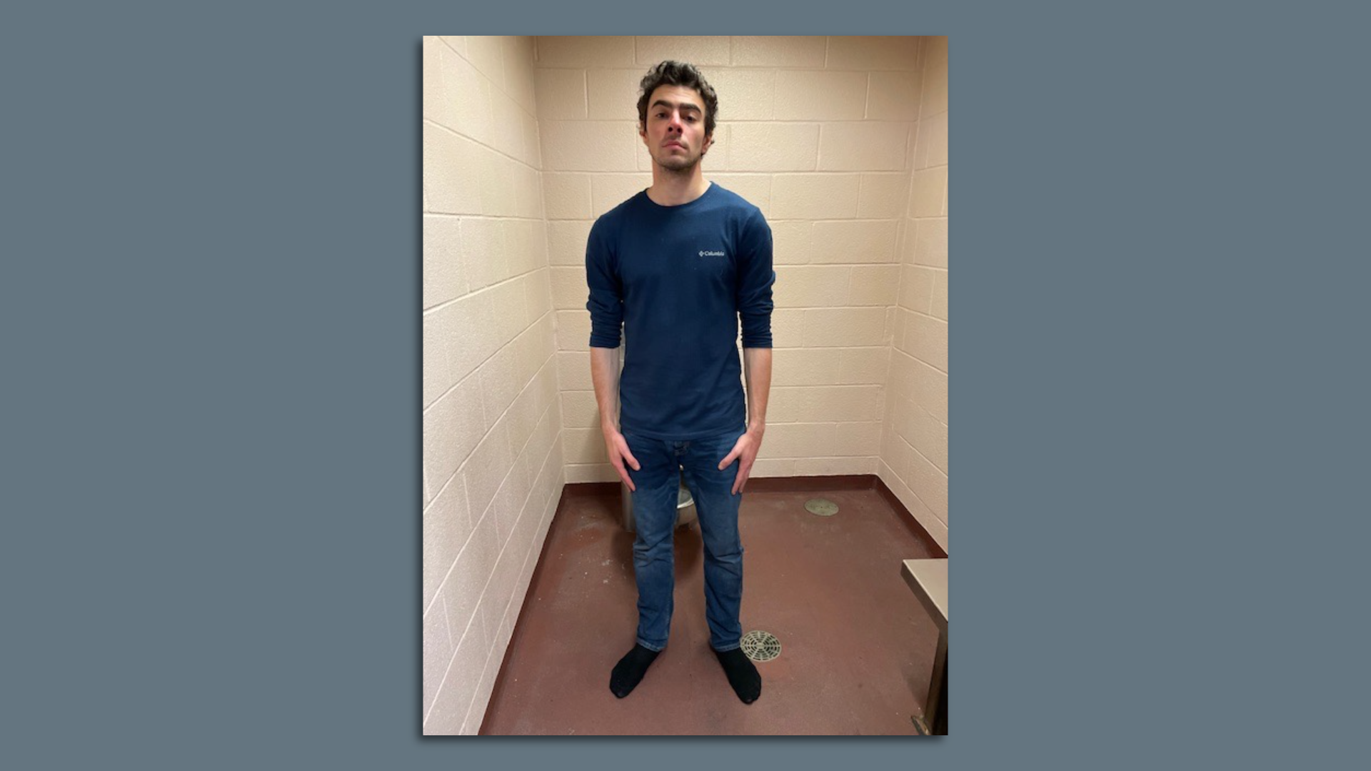 Luigi Mangione, a person of interest in the the fatal shooting of UnitedHealthcare CEO Brian Thompson, is seen on Monday in a holding cell after being taken into custody in Altoona, Pennsylvania and charged with five counts unrelated to the death.
