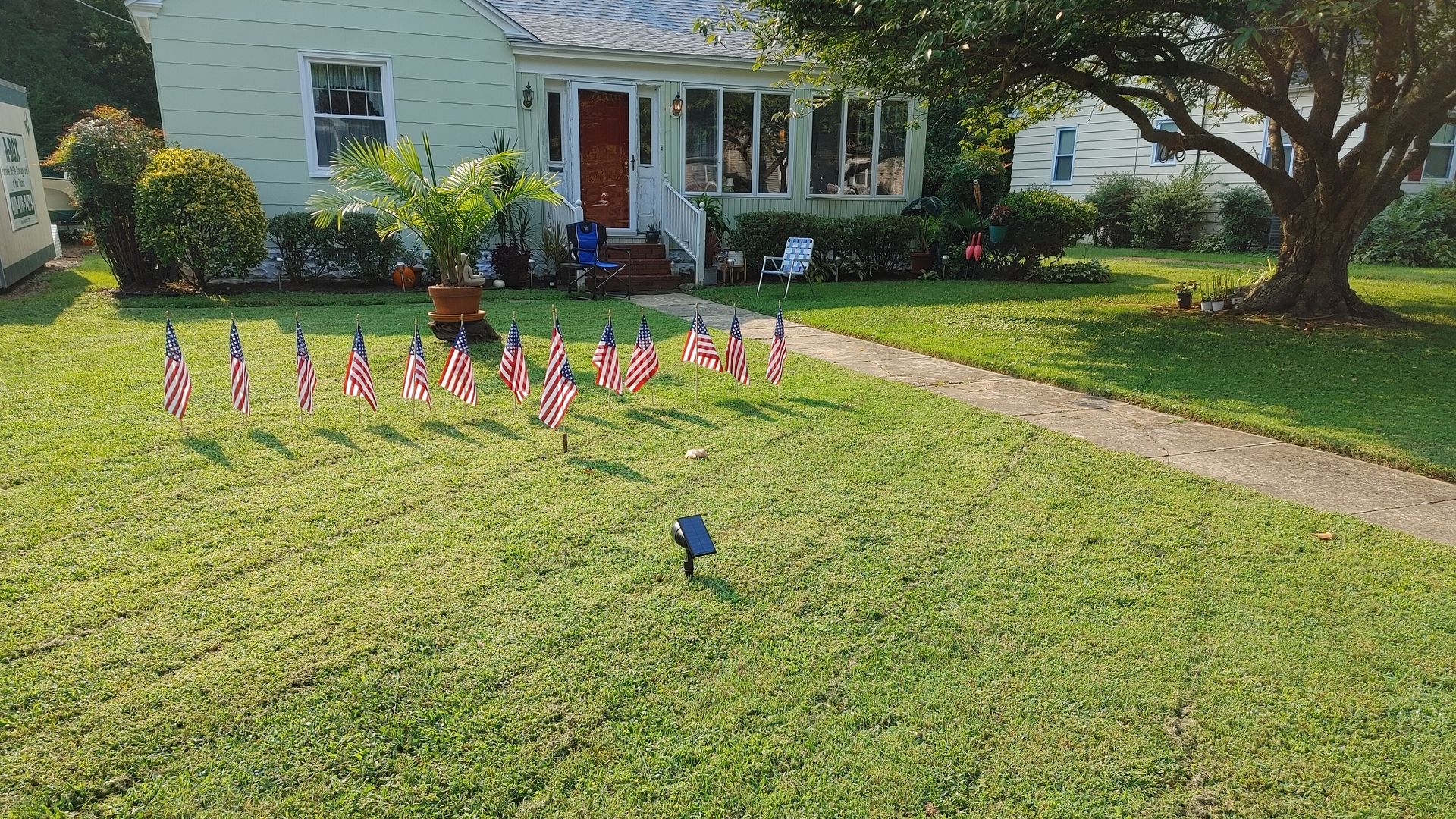 A house yard filled with American flags represented fallen service members in Kabul.