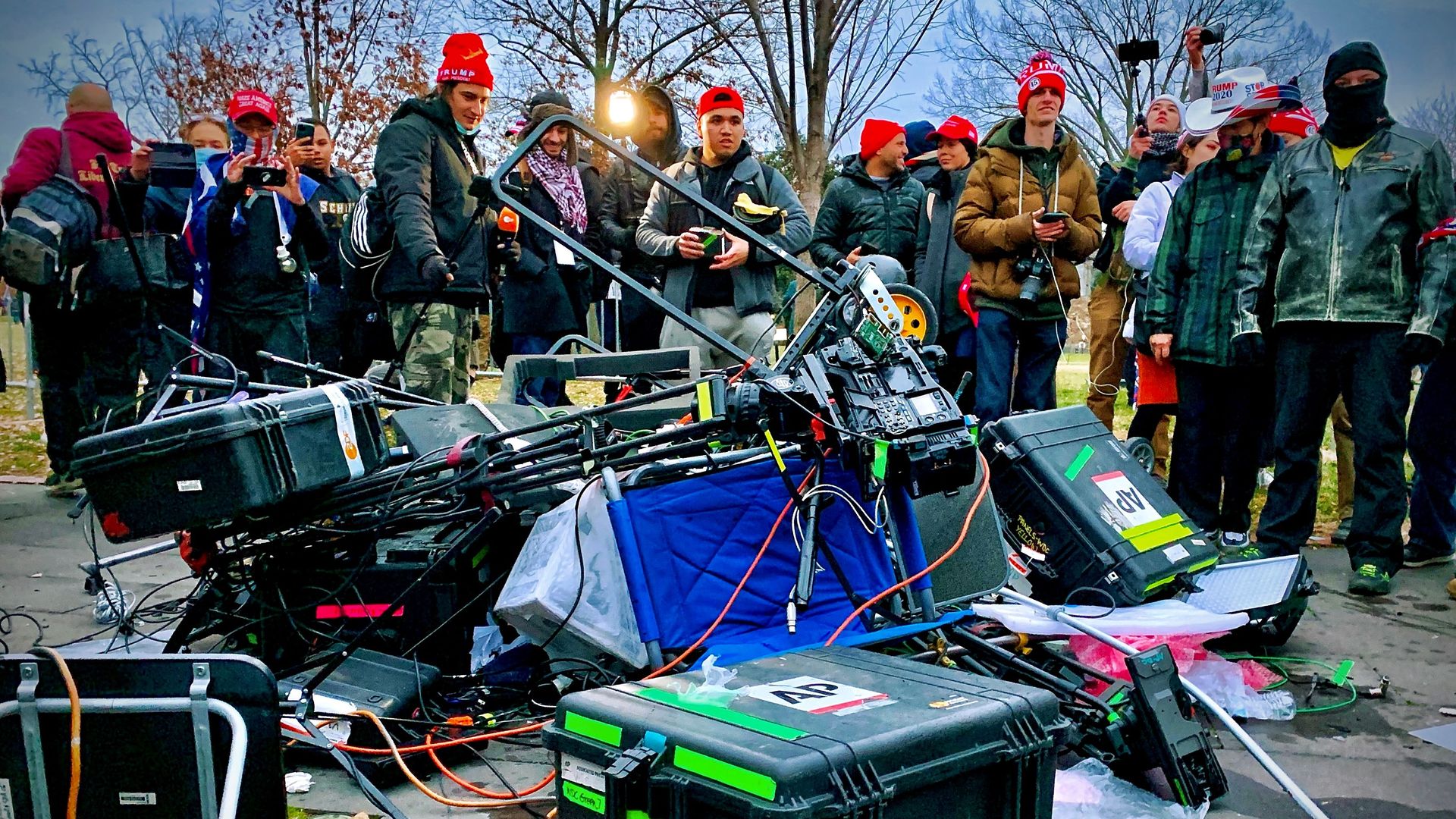 Supporters of US President Donald Trump stand next to media equipment they destroyed during a protest on January 6, 2021
