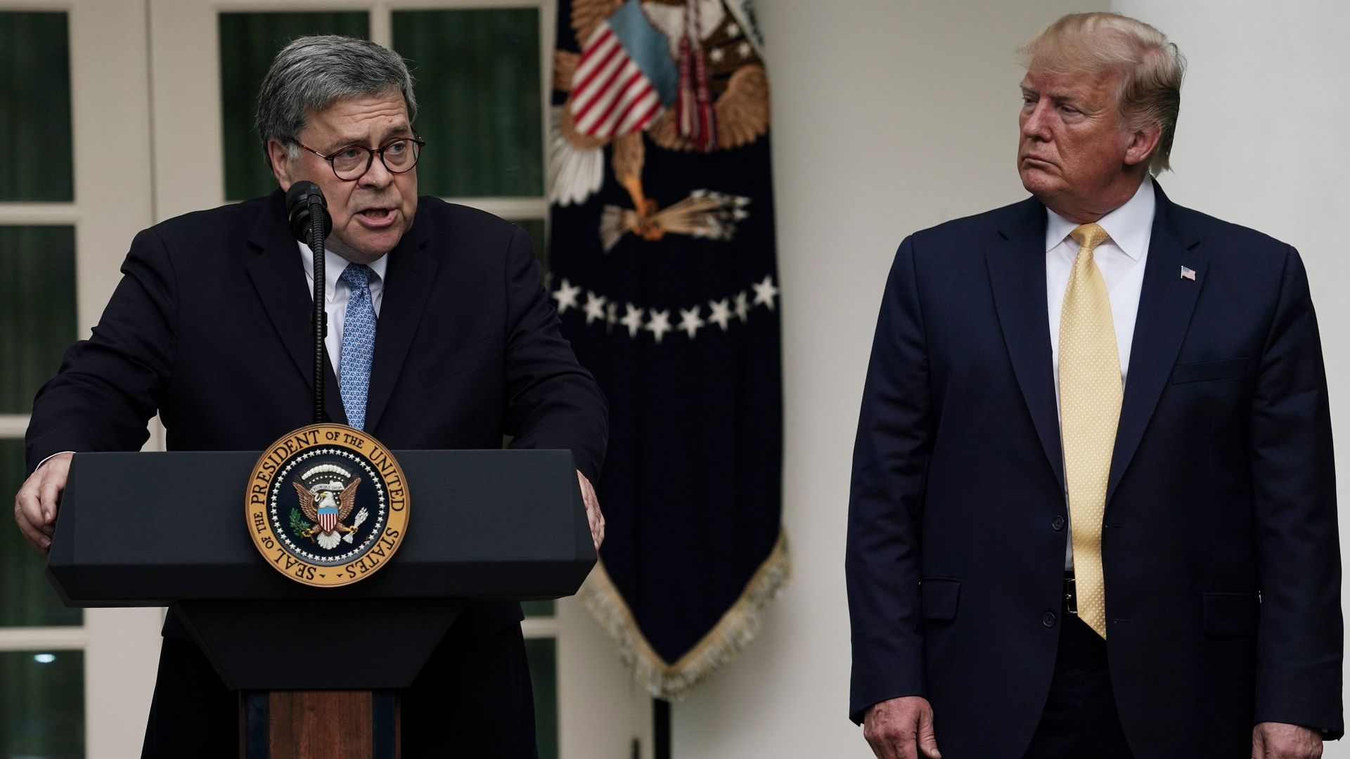 Attorney General William Barr speaks as President Donald Trump looks on during a Rose Garden statement on the census July 11