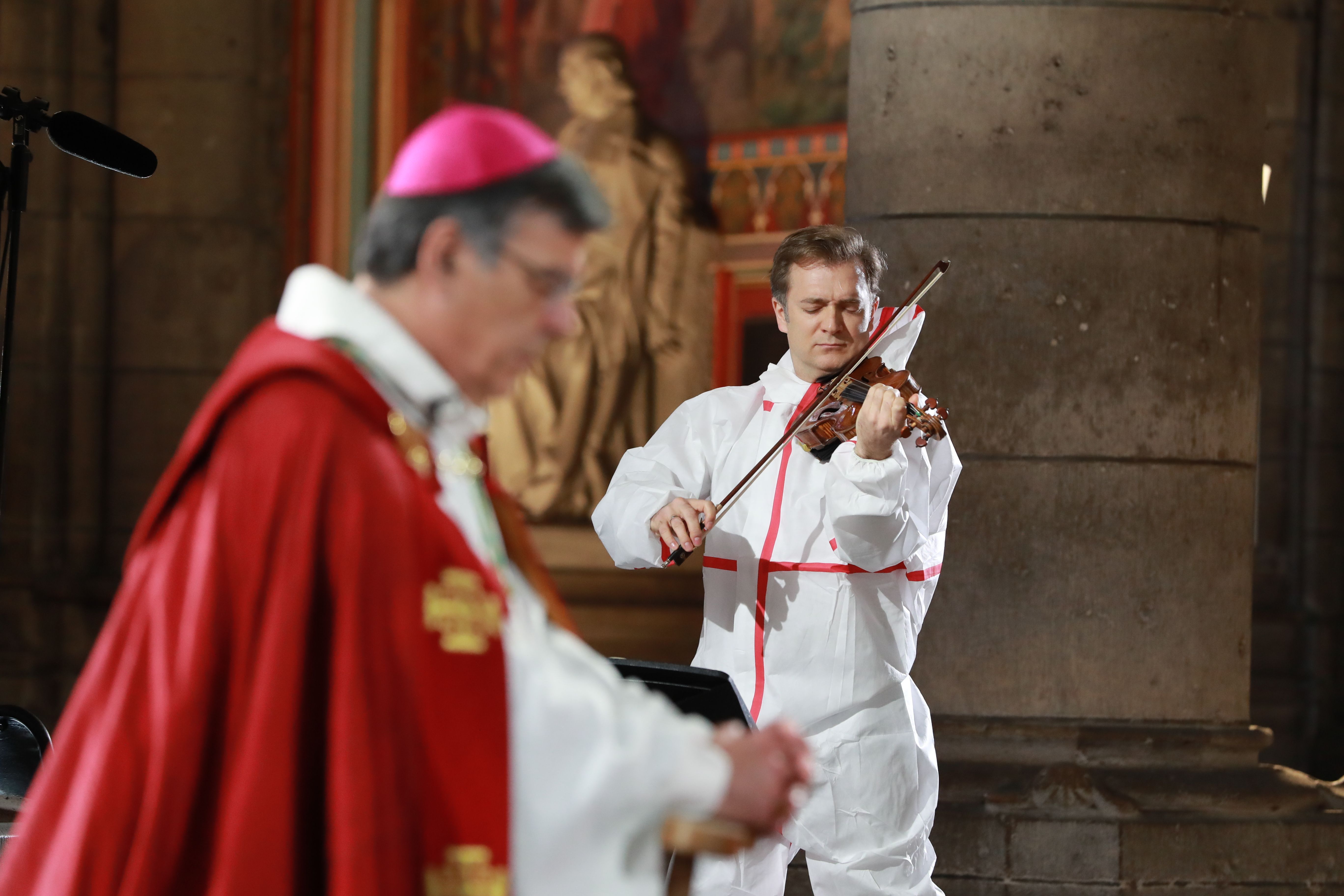 Archbishop of Paris Michel Aupetit attends a meditation ceremony to celebrate Good Friday as violonist Renaud Capucon plays