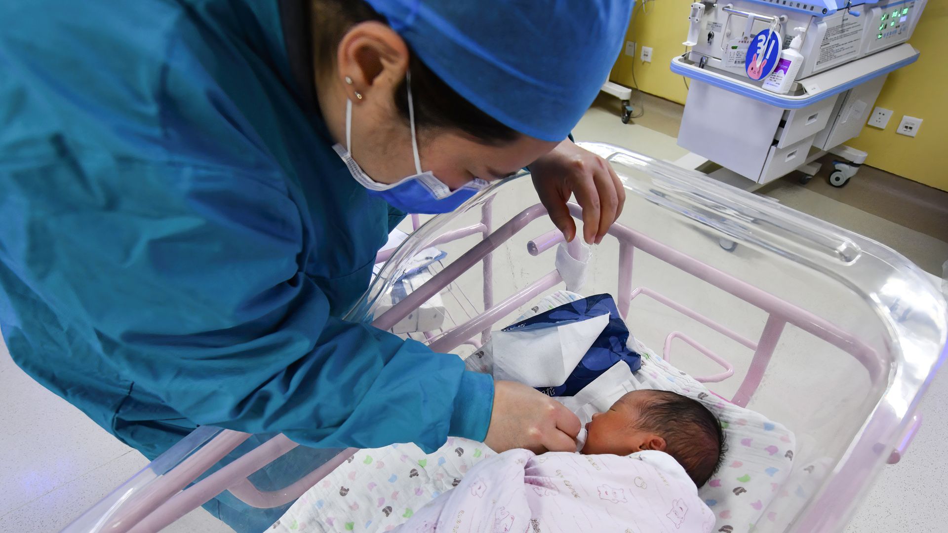 A newborn baby is seen being cared for in the ward of the hospital neonatal care center in Fuyang, Anhui, China, on April 25.