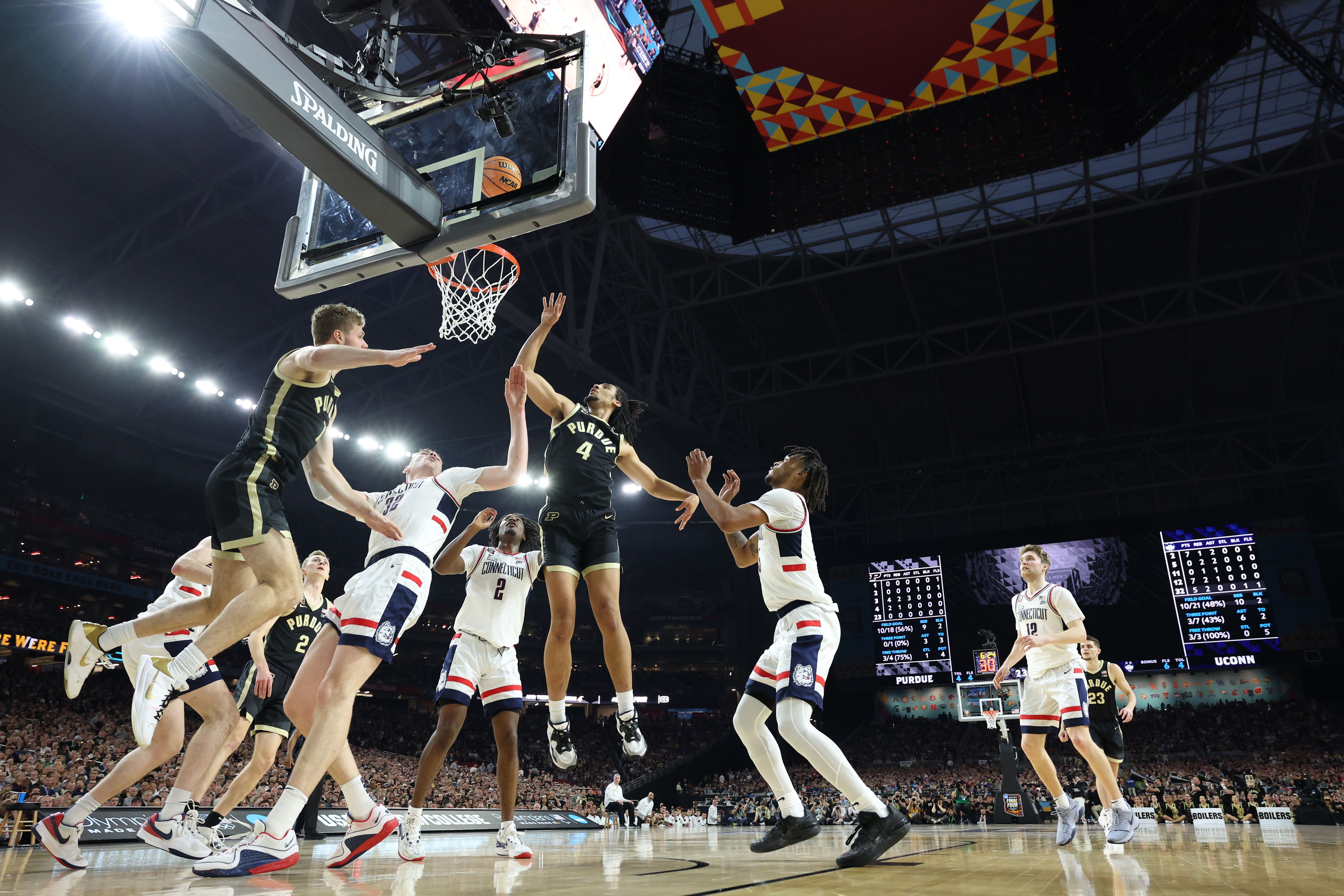 Trey Kaufman-Renn #4 of the Purdue Boilermakers attempts a shot while being guarded by Stephon Castle #5 of the Connecticut Huskies in the first half during the NCAA Men's Basketball Tournament National Championship game at State Farm Stadium on April 08, 2024 in Glendale, Arizona. 
