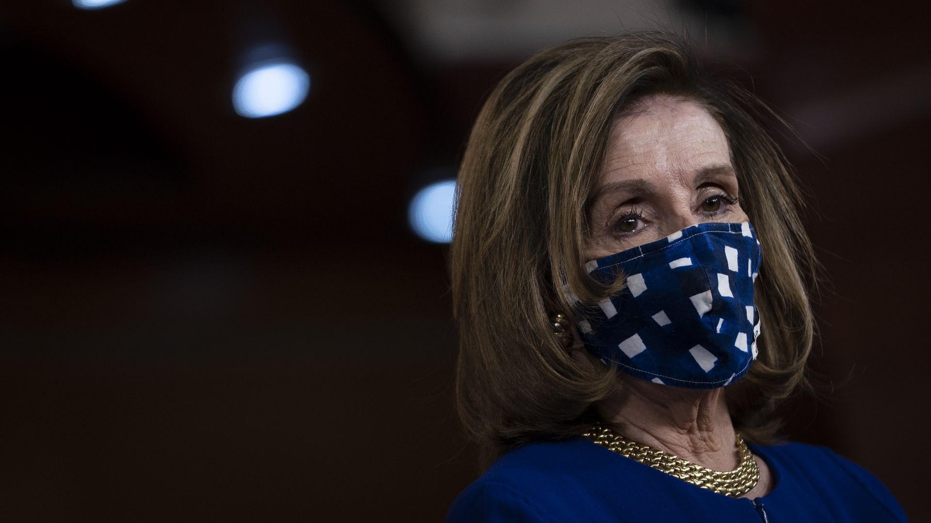 Nancy Pelosi wears a blue face mask 