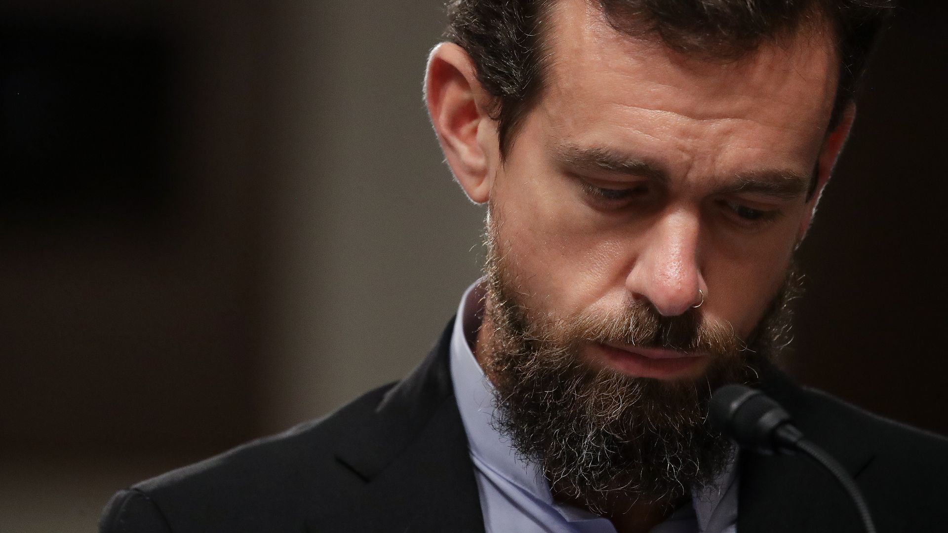 Jack Dorsey, looking down with a solemn expression on his face