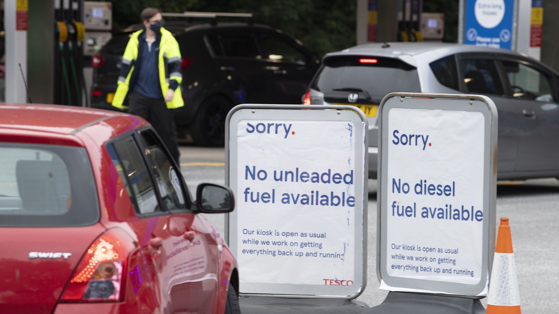 Signs at a Tesco Extra petrol station off Western Avenue which has run out of unleaded and diesel fuel but still has supplies of super unleaded fuel for sale on September 24