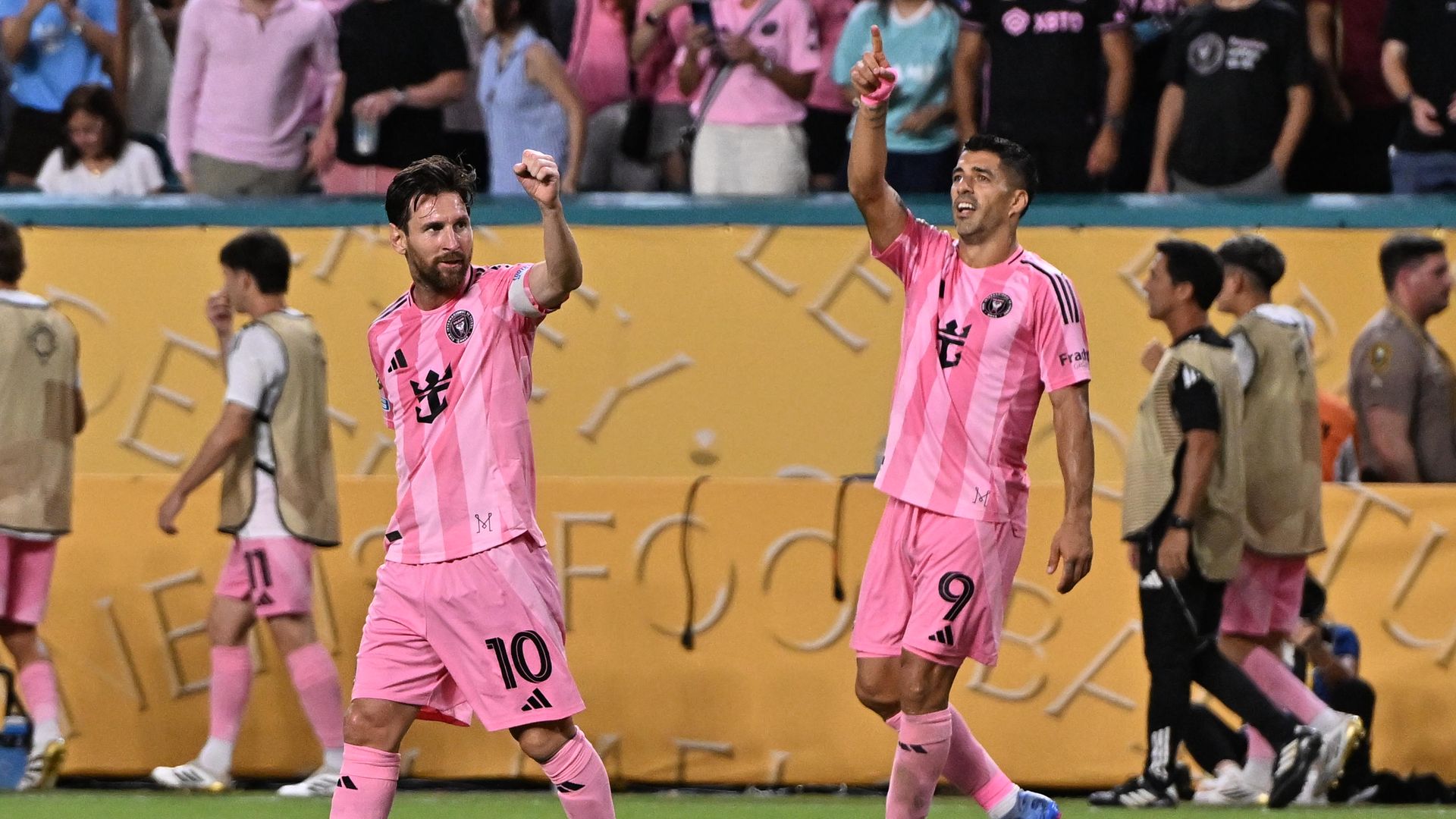 Two Inter Miami players walking on the field. 