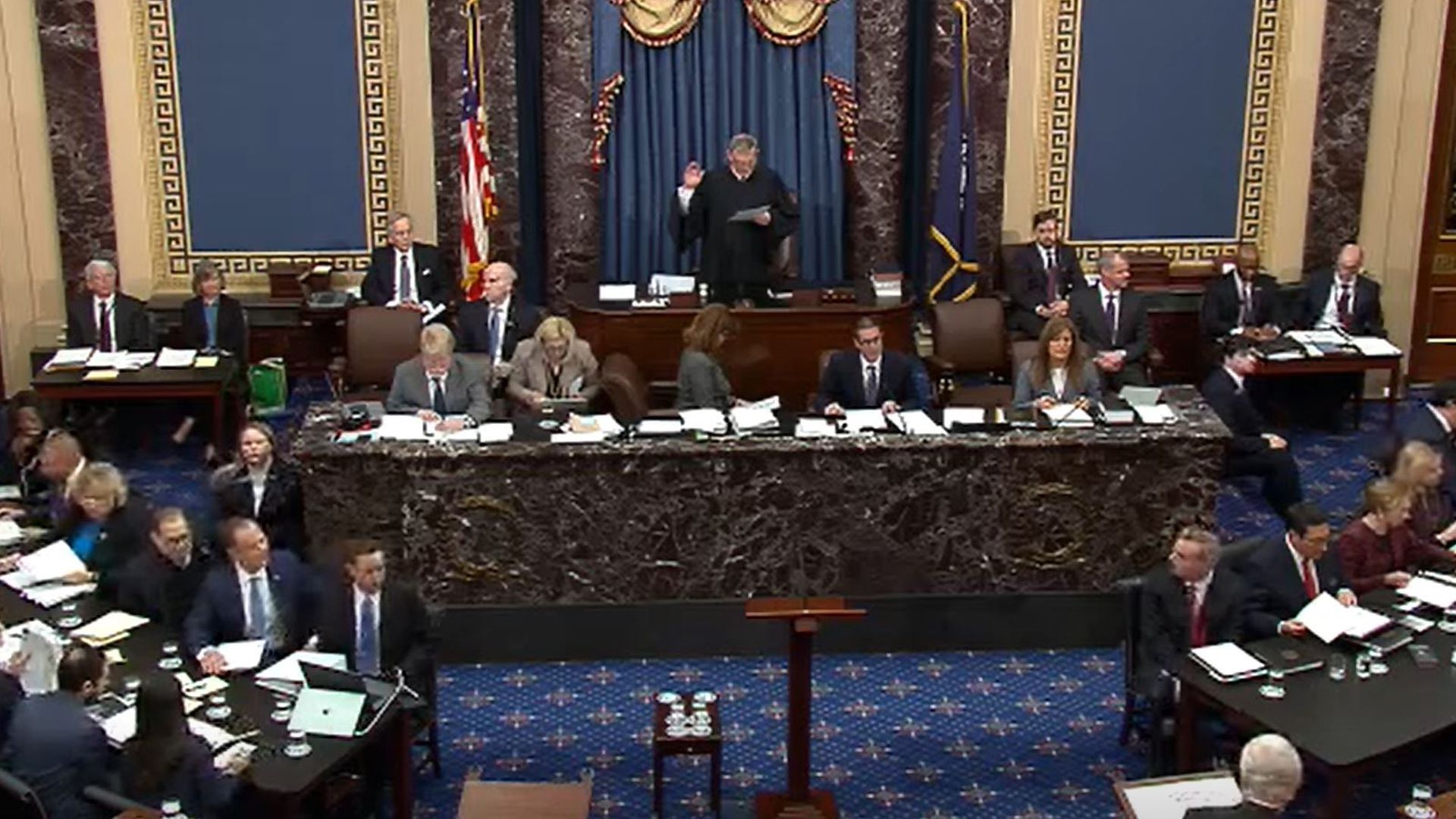 Chief Justice John Roberts swears in senators for President Trump's first impeachment.